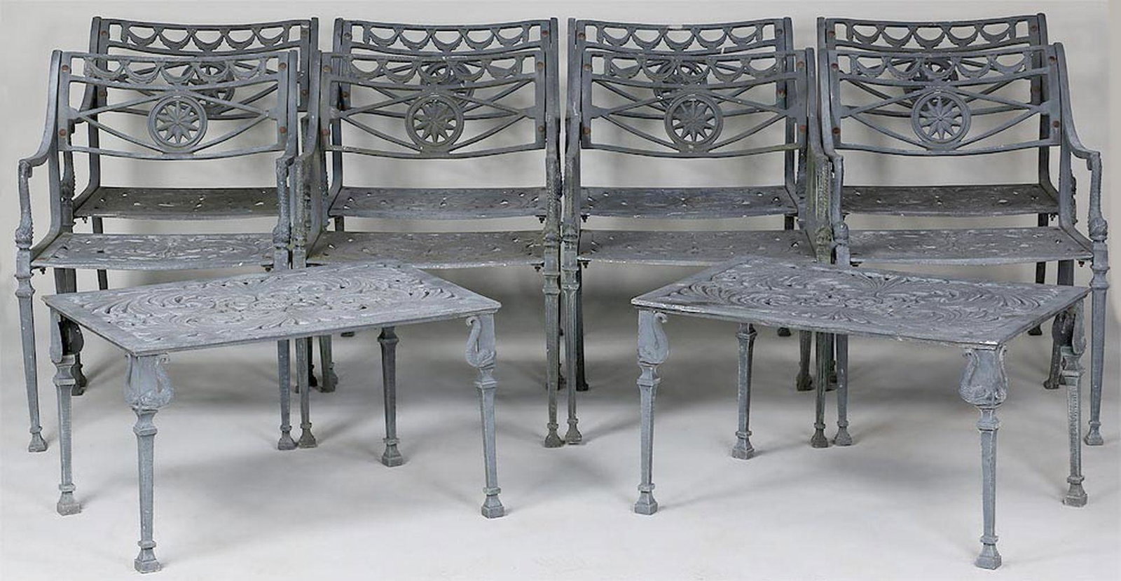 (8) Neoclassical style cast aluminum chairs: Set of (8) Neoclassical style cast aluminum garden armchairs, with dolphin support arms cast aluminum; and pair of matching side tables. One table with repair to leg. Chairs 30''h, 22''w, 22-3/4''d.