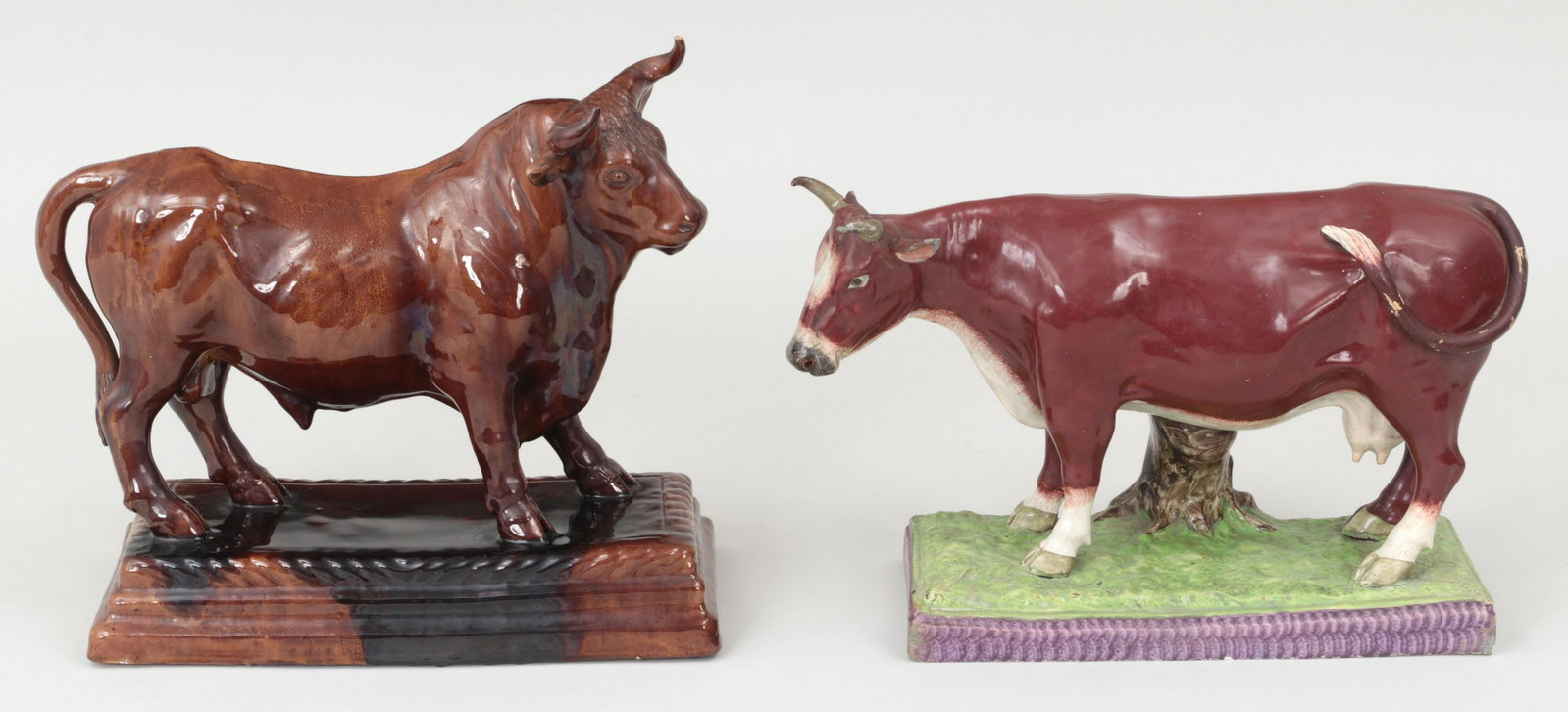 Group of (2) porcelain cows: Group of (2) porcelain cows, to include: MANUEL CIPRIANO GOMES MARFA (Portugal, Caldas, 1829-1905), majolica bull, stamped; and glazed porcelain cow with spill vase. Repairs and losses to both, firing