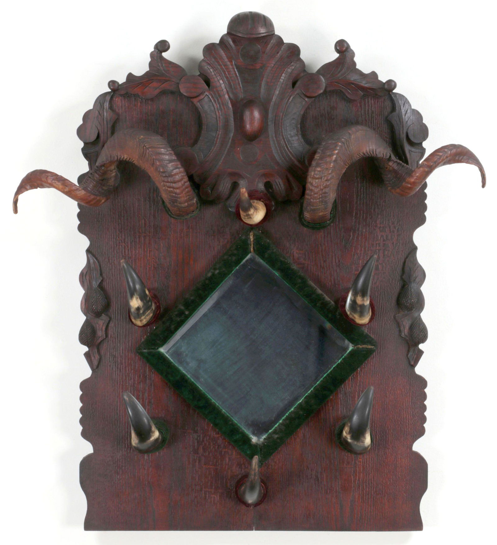Large coat rack: Large carved and stained oak wood coat rack, with beveled central mirror, and ram and steer horns serving as hooks. Some horns loosely mounted, splitting to wood and horns. 36''h, 31-1/4''w.
