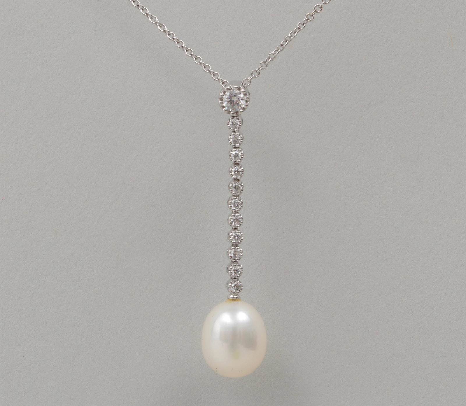 18k Leo Pizzo diamond and pearl necklace: 18k white gold Leo Pizzo diamond and pearl necklace having .15ct round cut diamond and (11) single cut diamonds, approximately .37 total carats, marked. 16-5/8''l. Total approximate weight 3.2 dwt.