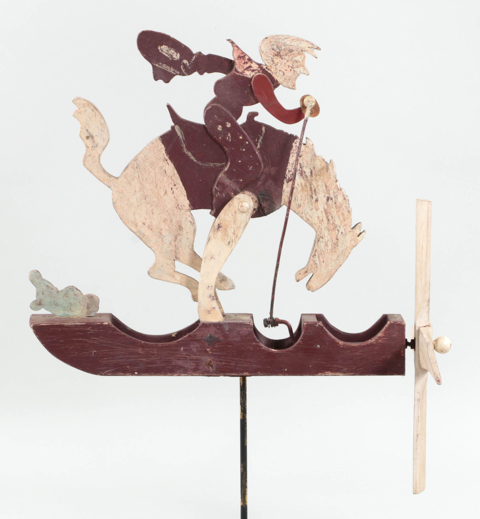 Bucking bronco whirligig: Bucking bronco whirligig, carved and painted wood. Minor splits and losses, repainted, weathered. 26-1/2''h, 15-3/4''w, 22-3/8''d.