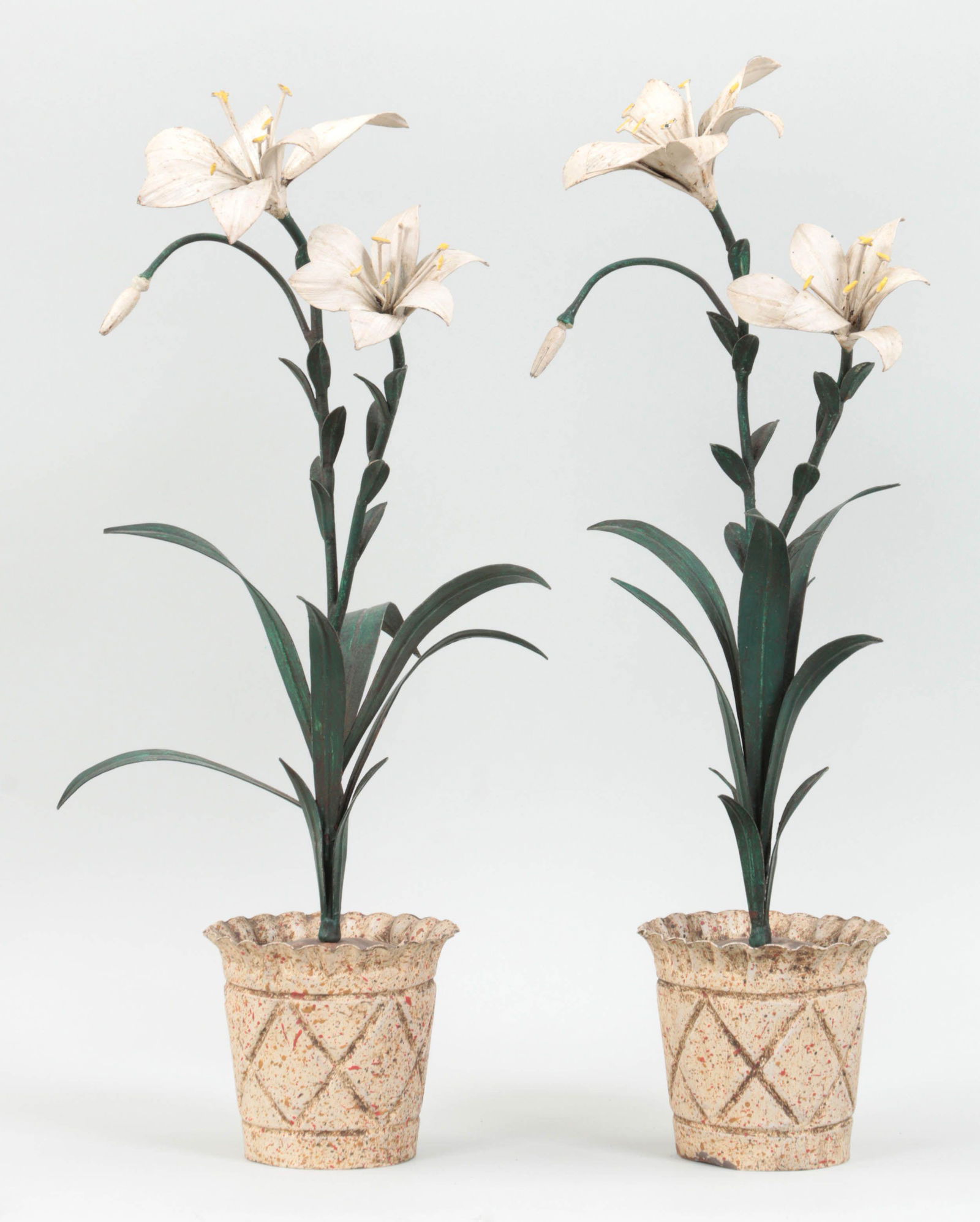 Pair of painted tole lilies: Pair of painted tole lilies in speckled pots. Paint loss in some areas, minor oxidation, and dents to pots. 22''h, 11''w, 9-1/4''d.