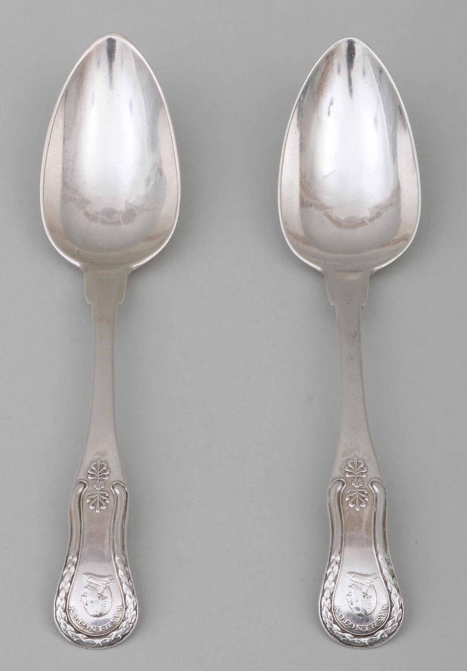 Spoons with busts of Washington.: Pair of early American dessert or coffee spoons, decorated with busts of Washington, Thomas Harland, Norwich, CT, circa 1800, or Henry Harland, Norwich, CT & New Orleans, LA, circa 1832, the bowls are