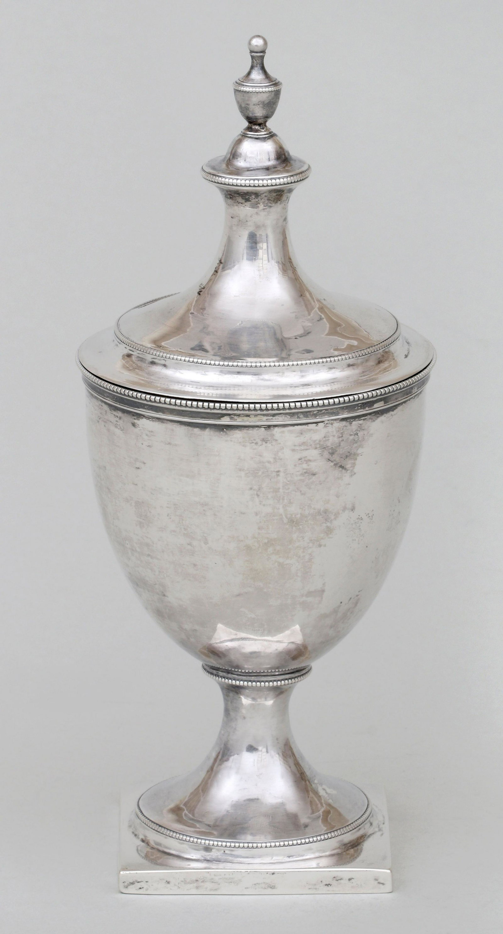 Moore & Ferguson, Philadelphia, PA, circa 1801-05.: Federal covered sugar urn, Moore & Ferguson (Charles Moore & John Ferguson), Philadelphia, PA, circa 1801-05, having cupola form cover with applied cast urn finial, chalice shaped body, tapering domed