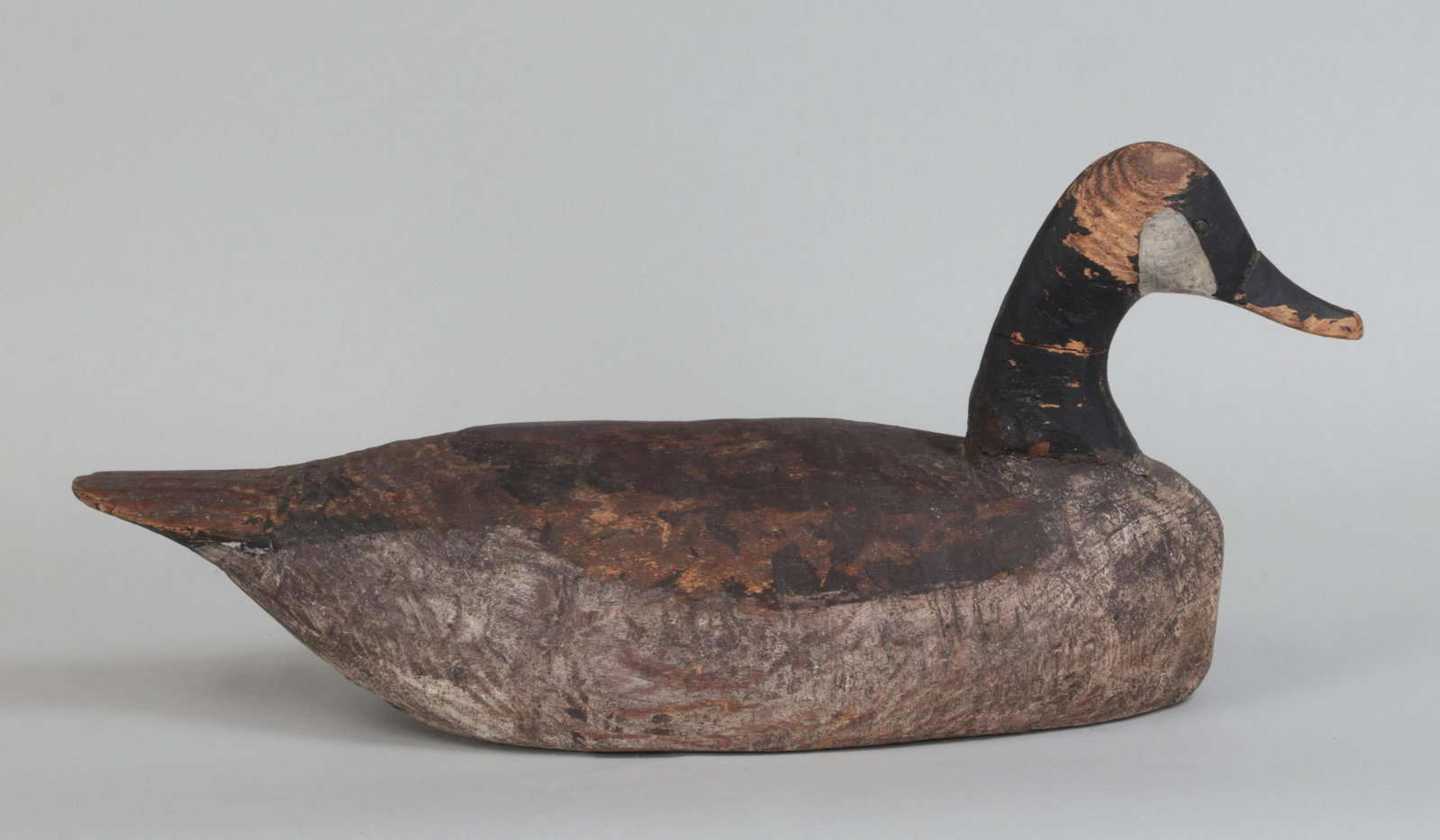 Canada Goose decoy: Canada Goose decoy attributed to MILES HANCOCK (American, 1887/88-1974). Appears to be mostly original paint with wear and right side of head is missing much of the paint. The tack eyes show some over