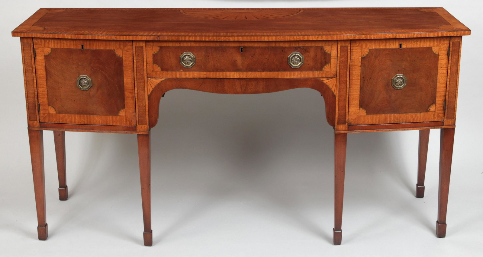 Hepplewhite sideboard: Hepplewhite sideboard with tiger maple crossbanding and fan inlay, raised on square tapering legs with spade feet. Some sun bleaching, minor loss or splitting of veneer. 36-1/4''h, 72''w, 24''d.
