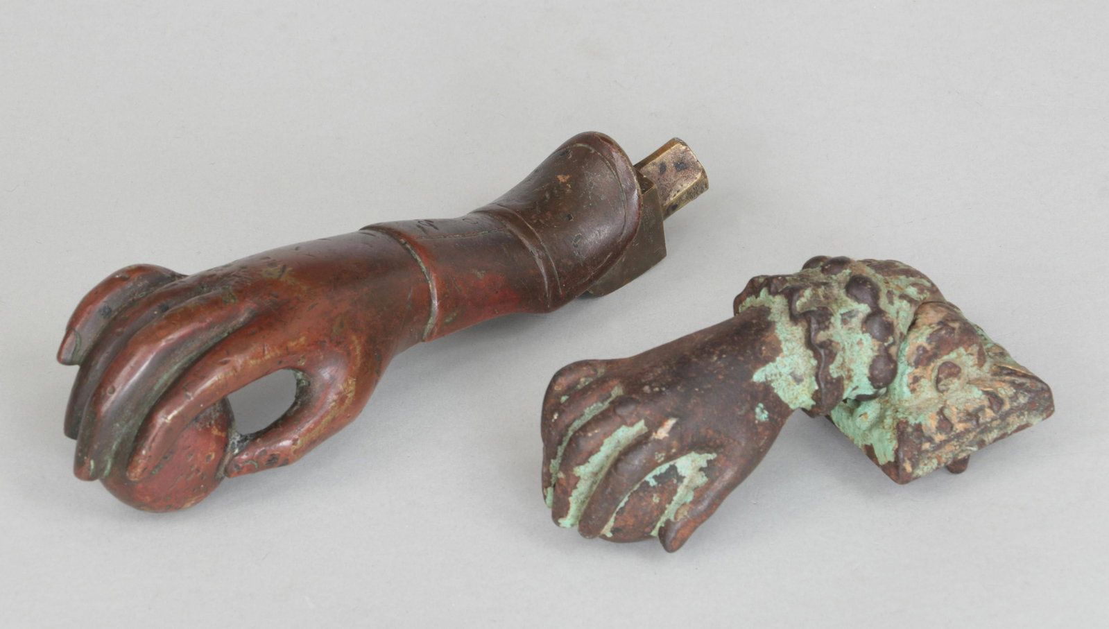 Group of (2) door knockers: Group of (2) brass and polychrome cast iron right hand door knockers, 19th century. Brass hand 7''l, 2''w, 2''d.