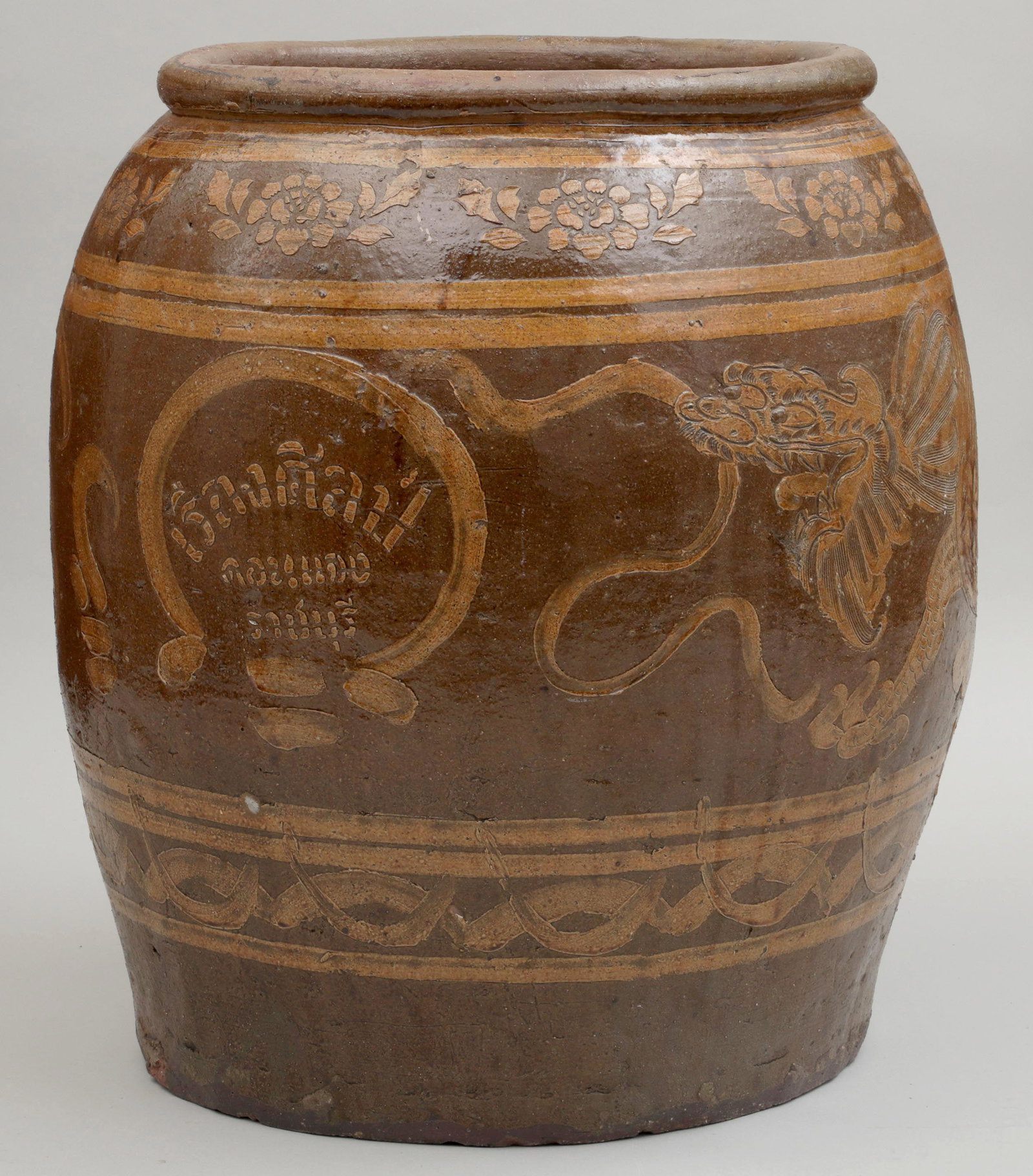 Large glazed Chinese garden urn: Large glazed Chinese earthenware garden urn, slip decorated with dragon. 27''h, 25''dia.