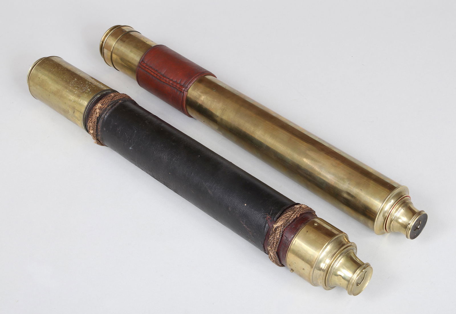 Harris & Son telescope: Group of (2) single-draw brass telescopes with dust slides, to include: English Harris & Son telescope with wood barrel wrapped in black leather having sailor knot wrapping, inscribed ''T. Harris & So