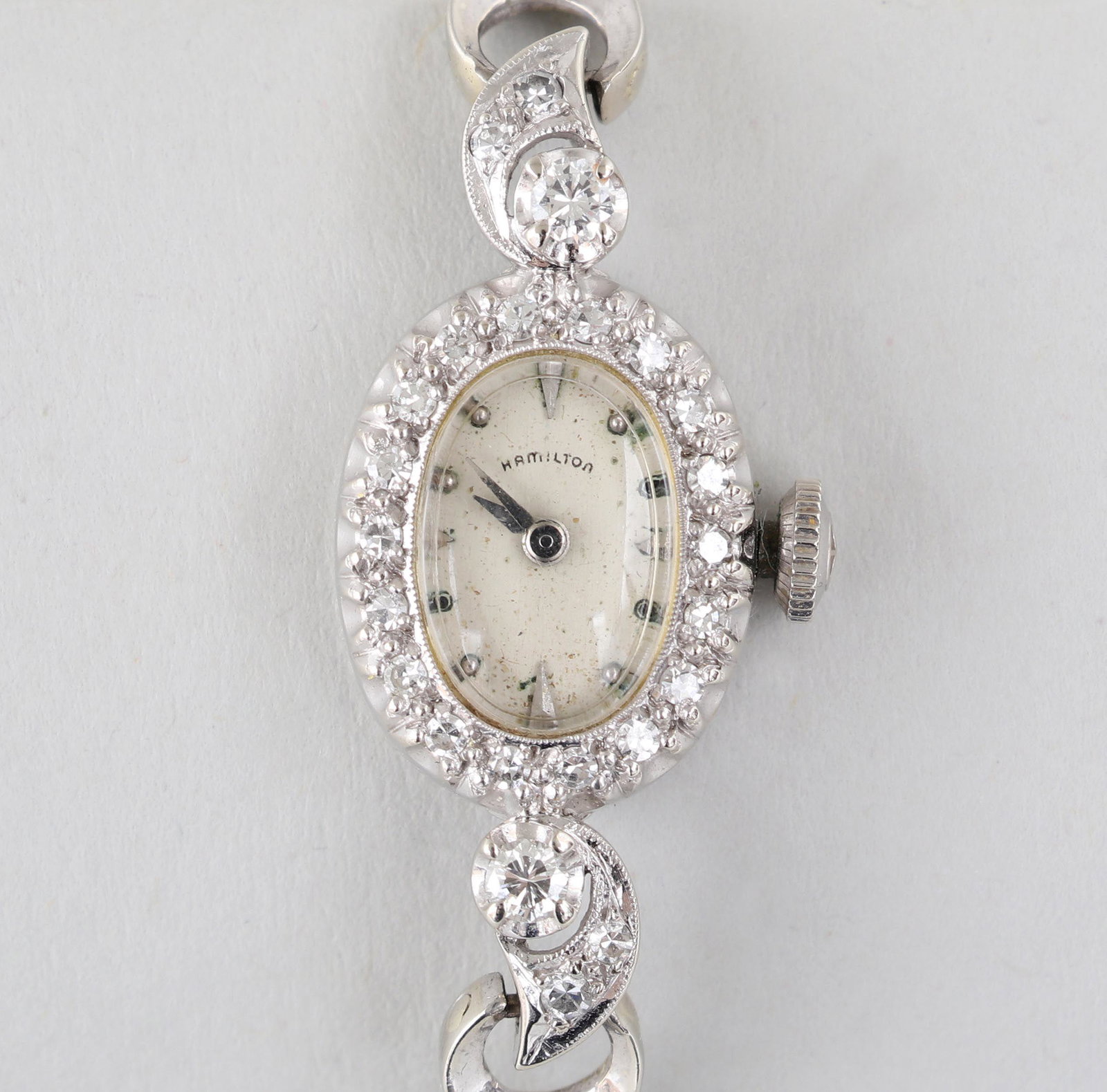 Diamond 14k bracelet watch: Hamilton diamond 14k white gold bracelet watch, with (42) single cut diamond accents to face and band, having Hamilton 22 jewel movement, ''H.D.A.'' monogrammed backplate, 14k marked on clasp and insi