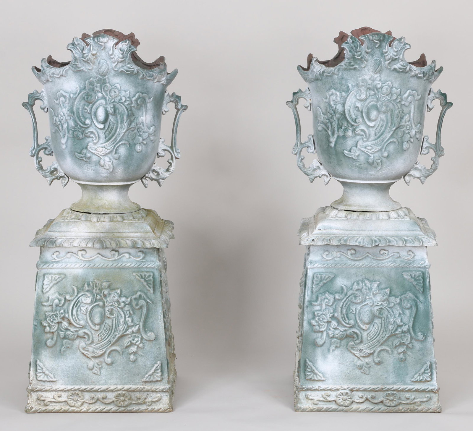 Pair of Rococo style cast aluminum urns: Pair of Rococo style cast aluminum urns-on-stands, one-piece construction. 40''h.