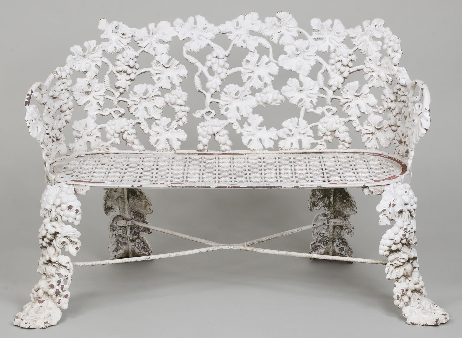 19th century cast iron garden bench: 19th century cast iron garden bench in grape pattern, signed ''John McLean, N.Y.'' Small loss to leaf at back, two replaced bolts. 31''h, 46''w, 25-1/2''d.