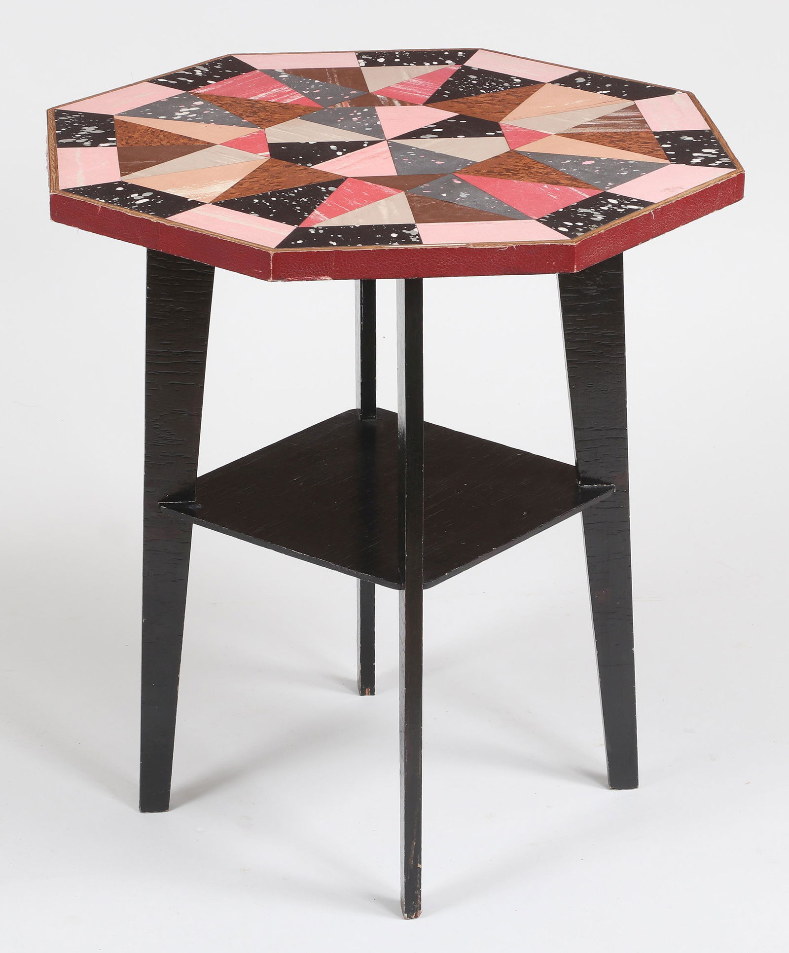 Linoleum mosaic-top side table: Linoleum mosaic-top side table with octagonal top set on ebonized base having tapering legs and stretcher shelf. Needs tightening, wear from use. 24-1/2''h. 22-3/4''sq. Provenance: Estate of Laura Fis
