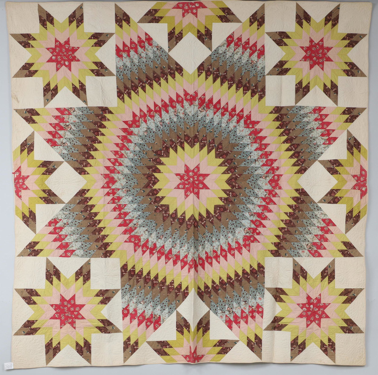 Rare Starburst Chintz Star of Bethlehem quilt: Rare Starburst Chintz Star of Bethlehem quilt with satellite stars, circa 1840s, with quilting in wreath, flower and leaf forms in all the ivory areas, and outline quilting around all the diamond shap