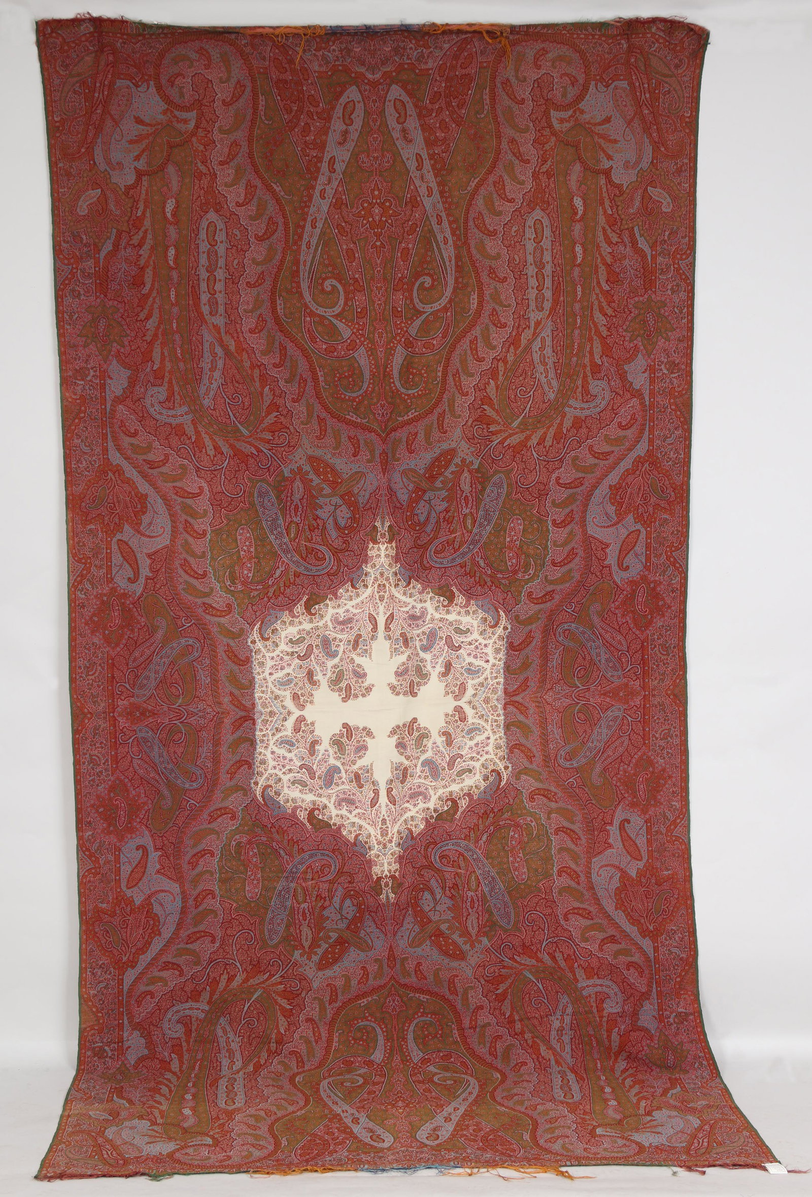Paisley shawl: Paisley shawl with white center medallion. 123''h, 61''w. Minor fraying to edges. Provenance: Estate of Laura Fisher, New York, NY.
