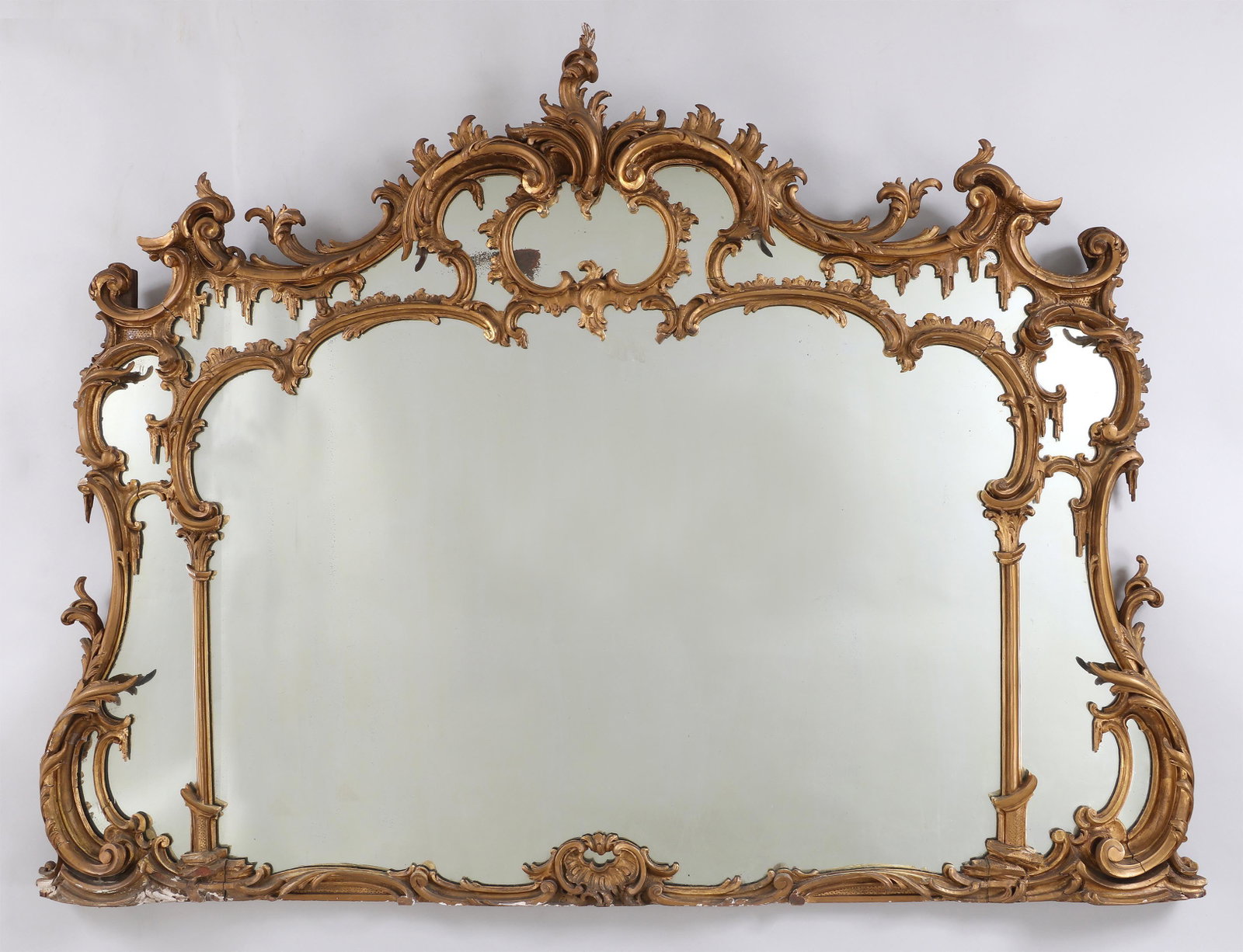 Large 19th century Chippendale style mirror: Large 19th century Chippendale style giltwood overmantle mirror. Several repairs and losses, some loss of silvering. 51''h, 69''w.