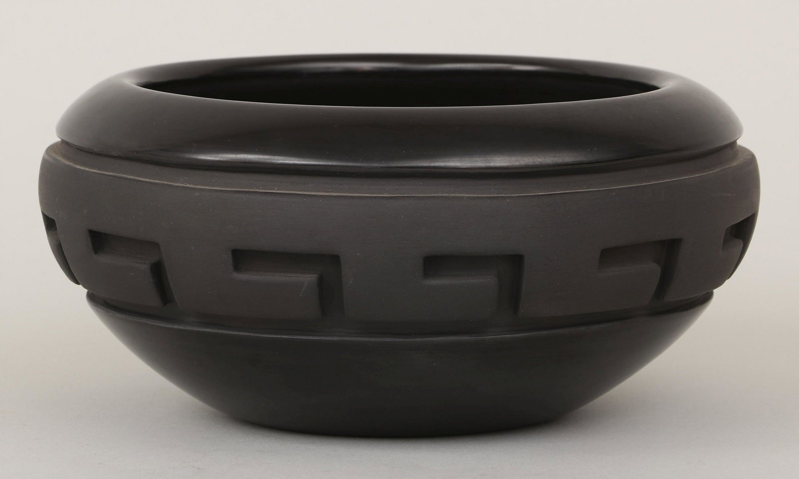 NATHAN YOUNGBLOOD (Santa Clara Pueblo, b. 1954): NATHAN YOUNGBLOOD (Santa Clara Pueblo, b. 1954), Santa Clara carved blackware bowl, signature and cipher incised to bottom, Sotheby's tag adhered to bottom. Minor surface stains. 4-1/2''h, 9''dia. Pro