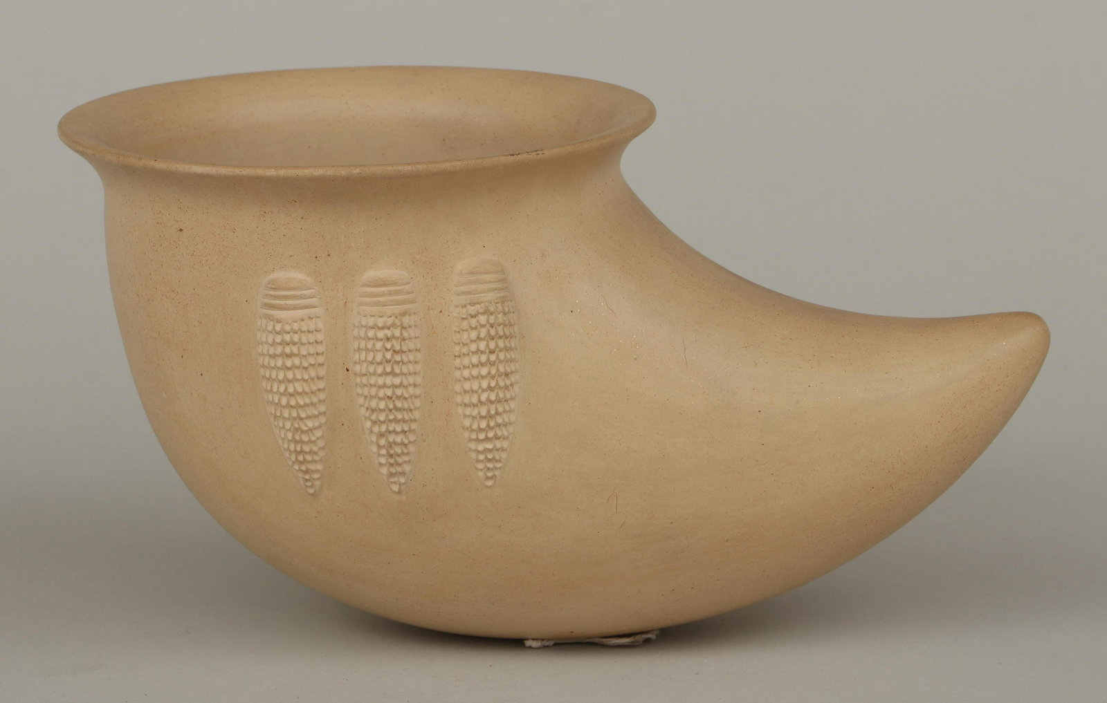 AL QOYAWAYMA (Hopi, b. 1938): AL QOYAWAYMA (Hopi, b. 1938), cornucopia-shaped buffware vessel, with three ears of corn in relief, signed and dated '''80-8-57'' to bottom, with Sotheby's tag adhered to bottom. Crazing to glaze, sta