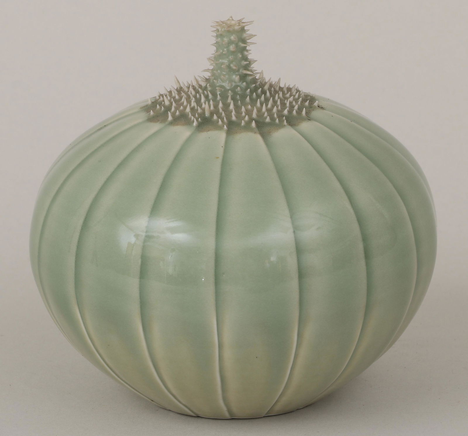 CLIFF LEE (American, b. 1951): CLIFF LEE (American, b. 1951), ''Prickly Melon'' porcelain art vase in celadon glaze, signed and dated '''97'' to bottom. Minor losses to spikes, dirt and grime around spikes. 5''h.