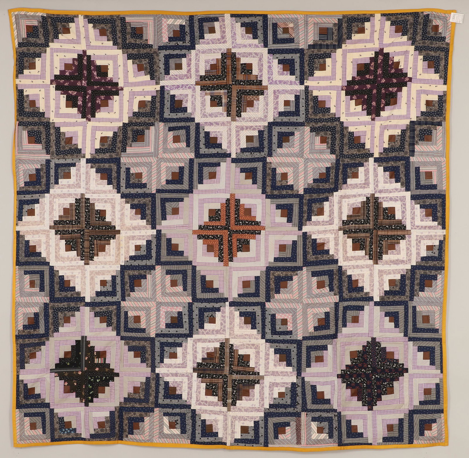 Mini Barn Raising Log Cabin quilt: Mini Barn Raising Log Cabin quilt, with knotted mustard backing and trim. 70''h, 70''w. Provenance: Estate of Laura Fisher, New York, NY.