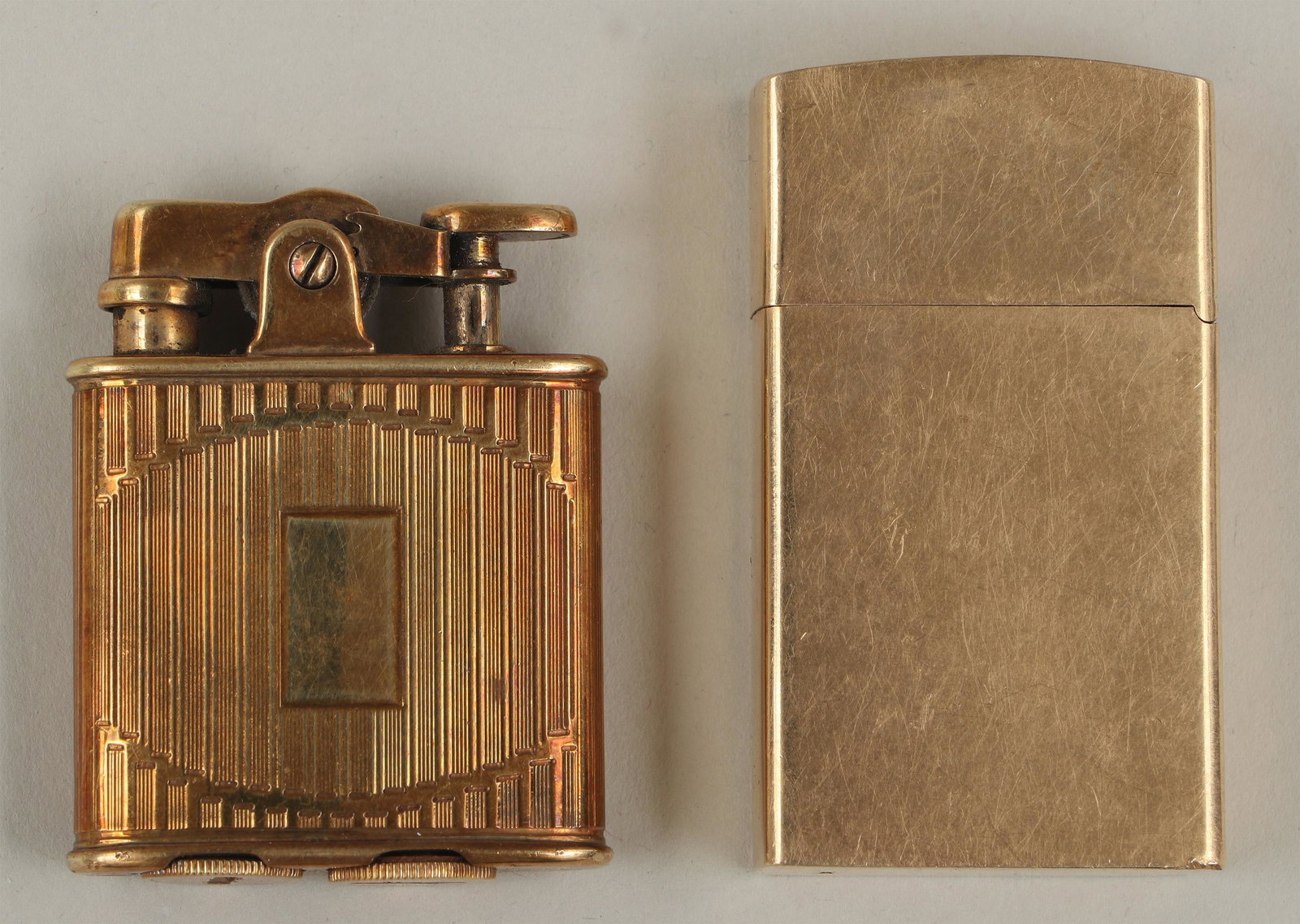 Group of (2) 14k gold lighters: Group of (2) 14k gold lighters, to include: Ronson ''Junior De Light'' women's lighter, with monogram, ''14K'', maker's mark and patent date to bottom; and Zippo lighter, monogrammed to side, marked '