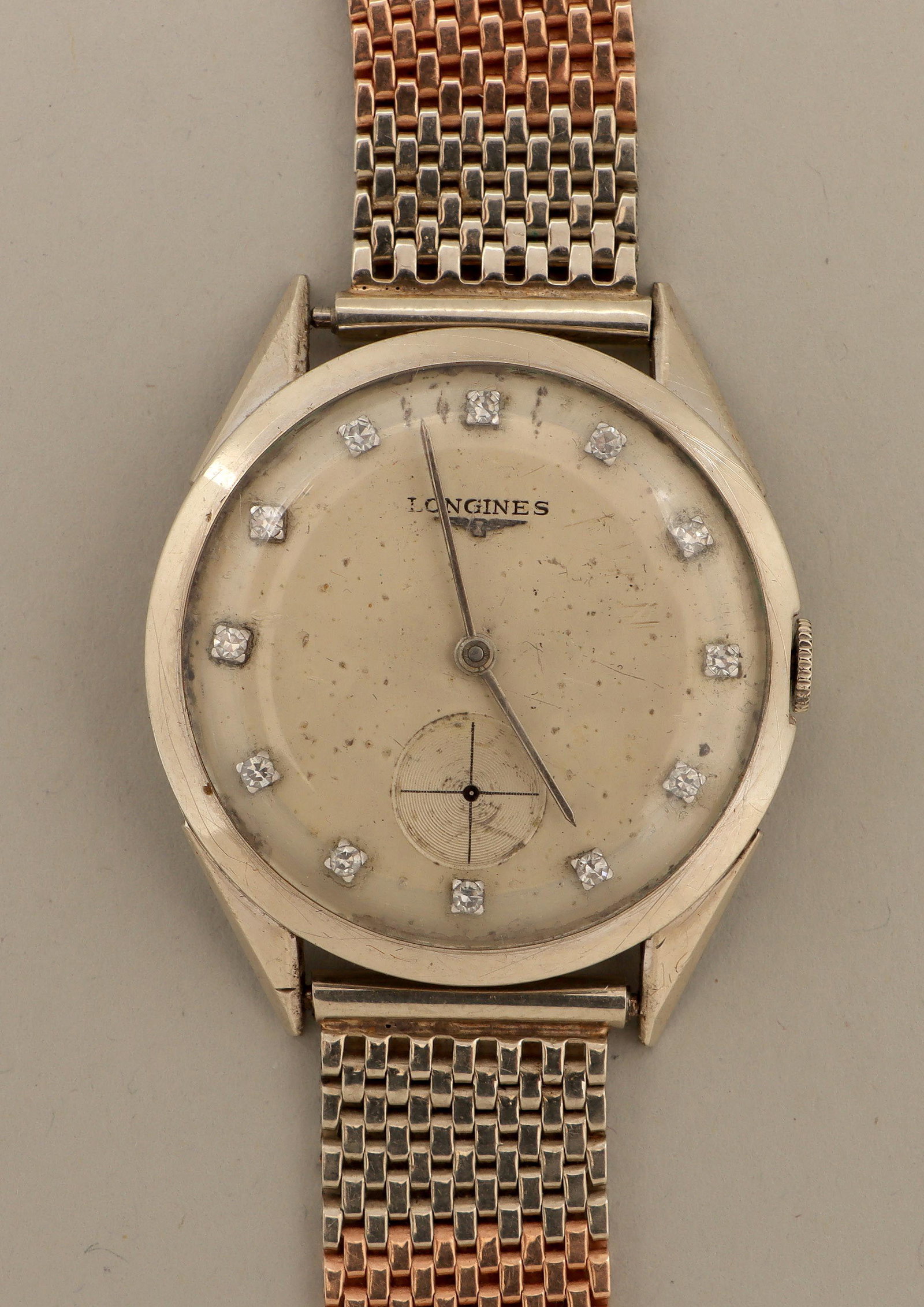 Longines diamond and 14k: Longines diamond and 14k white and rose gold women's wristwatch, 17 jewels, having round face with (12) diamonds and alternating white and rose gold mesh band, marked and numbered inside case and on m