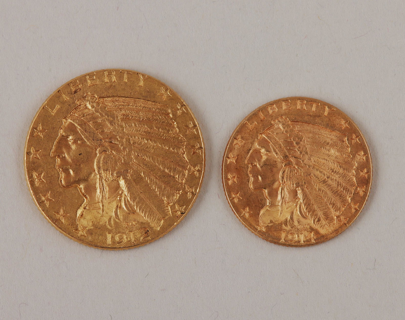 1912 & 1914 Indian Head-Eagle: Group of (2) Indian Head-Eagle gold coins, to include: five dollar, dated 1912; and two-and-a-half dollar, dated 1914. Five dollar 21mm dia; two-and-a-half dollar 17.5mm dia. Total approximate weight 