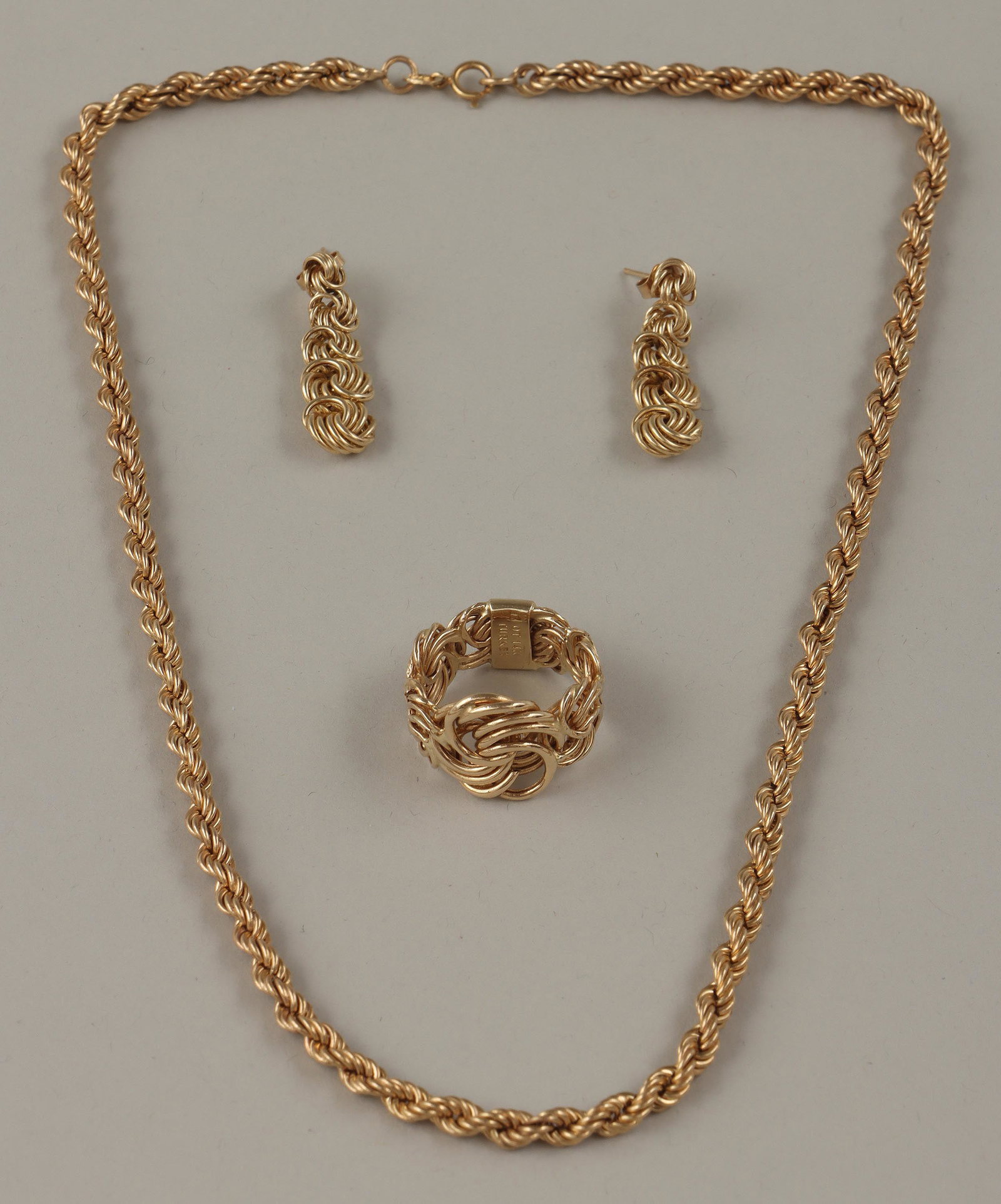 Group of (3) 14k jewelry: Group of (3) 14k gold rope chain jewelry, to include: necklace, marked to clasp; flattened rope chain ring, made in Turkey, signed ''OT'' and marked inside band; and pair of dangle earrings, with piec