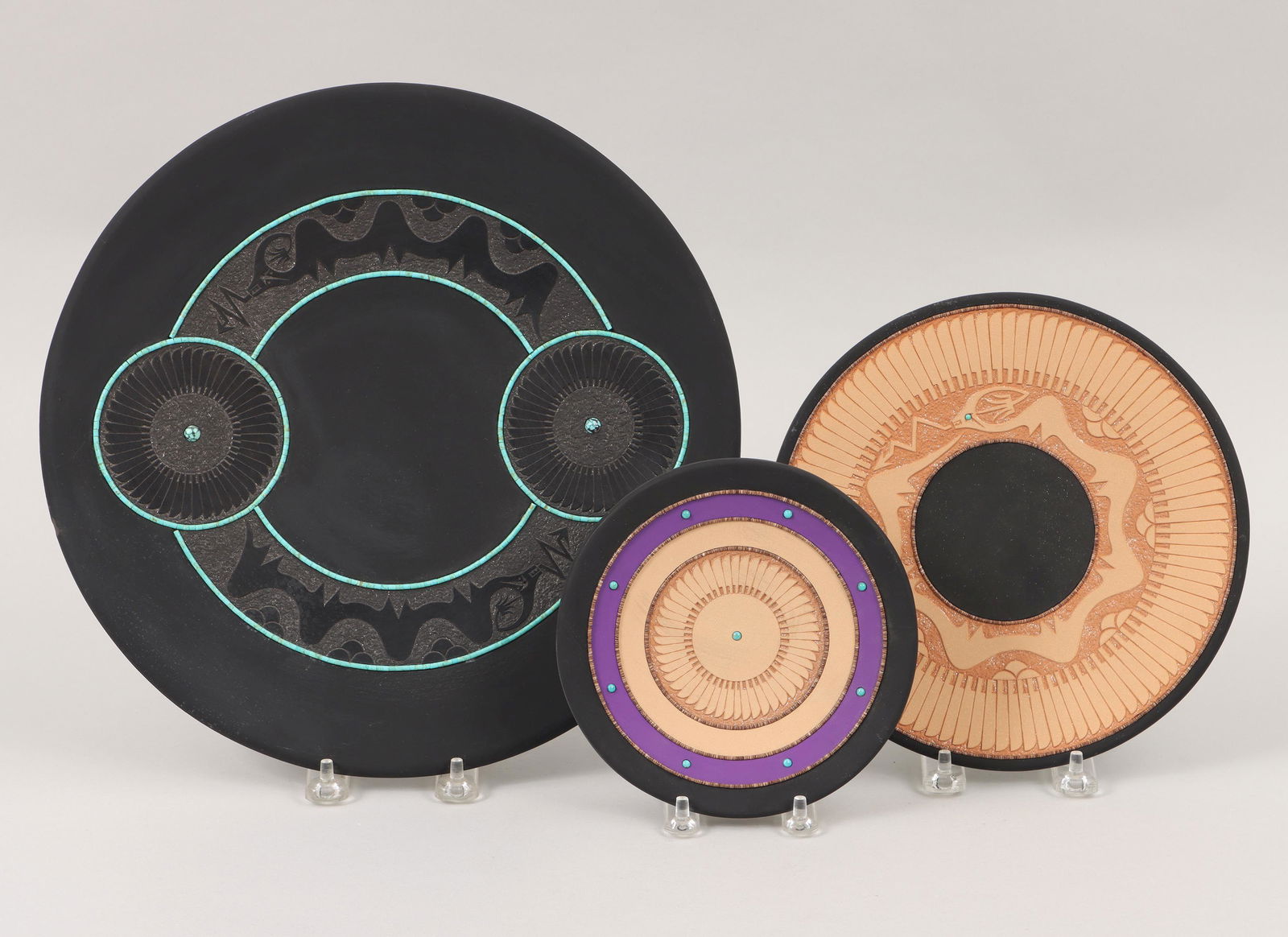 JOHN GONZALES: JOHN GONZALES (San Ildefonso Pueblo, b. 1955), group of (3) blackware plates decorated with beads, turquoise cabochons, and having incised designs with micaceous clay slips, to include: large plate ha