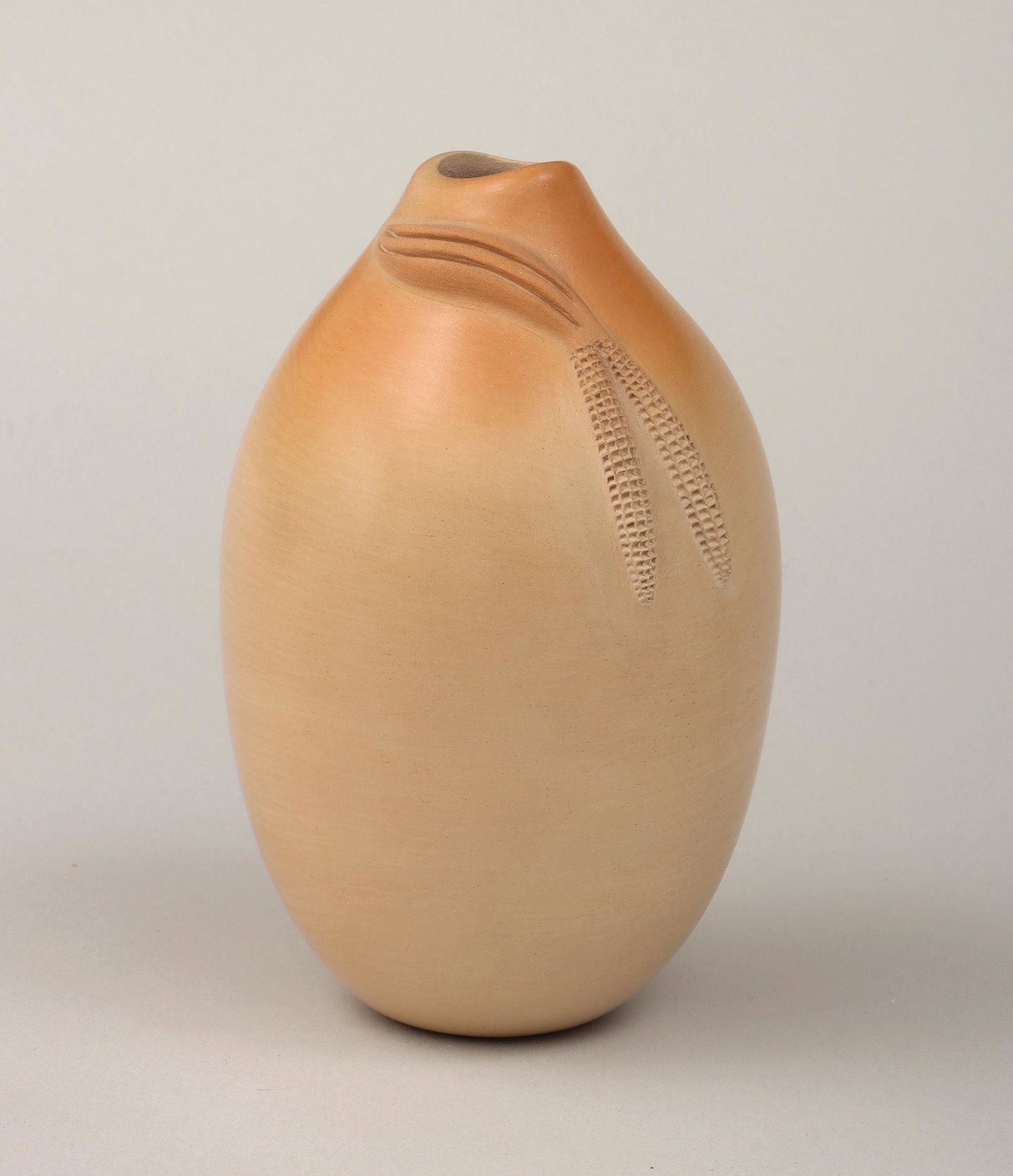 IRIS YOUVELLA NAMPEYO: IRIS YOUVELLA NAMPEYO (Hopi-Tewa, 1944-2018), buff-colored seed jar with applied ears of corn, signed and numbered ''1612-069'' to bottom. 7''h, 4''dia.