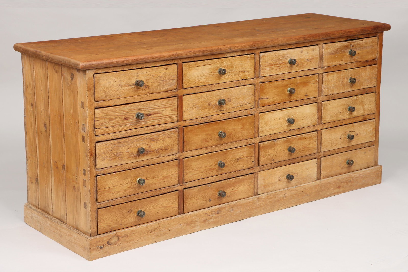 Pine twenty-drawer apothecary: Pine twenty-drawer apothecary. Wear from use, repairs and modifications. 31-1/2''h, 66''w, 21-1/2''d.
