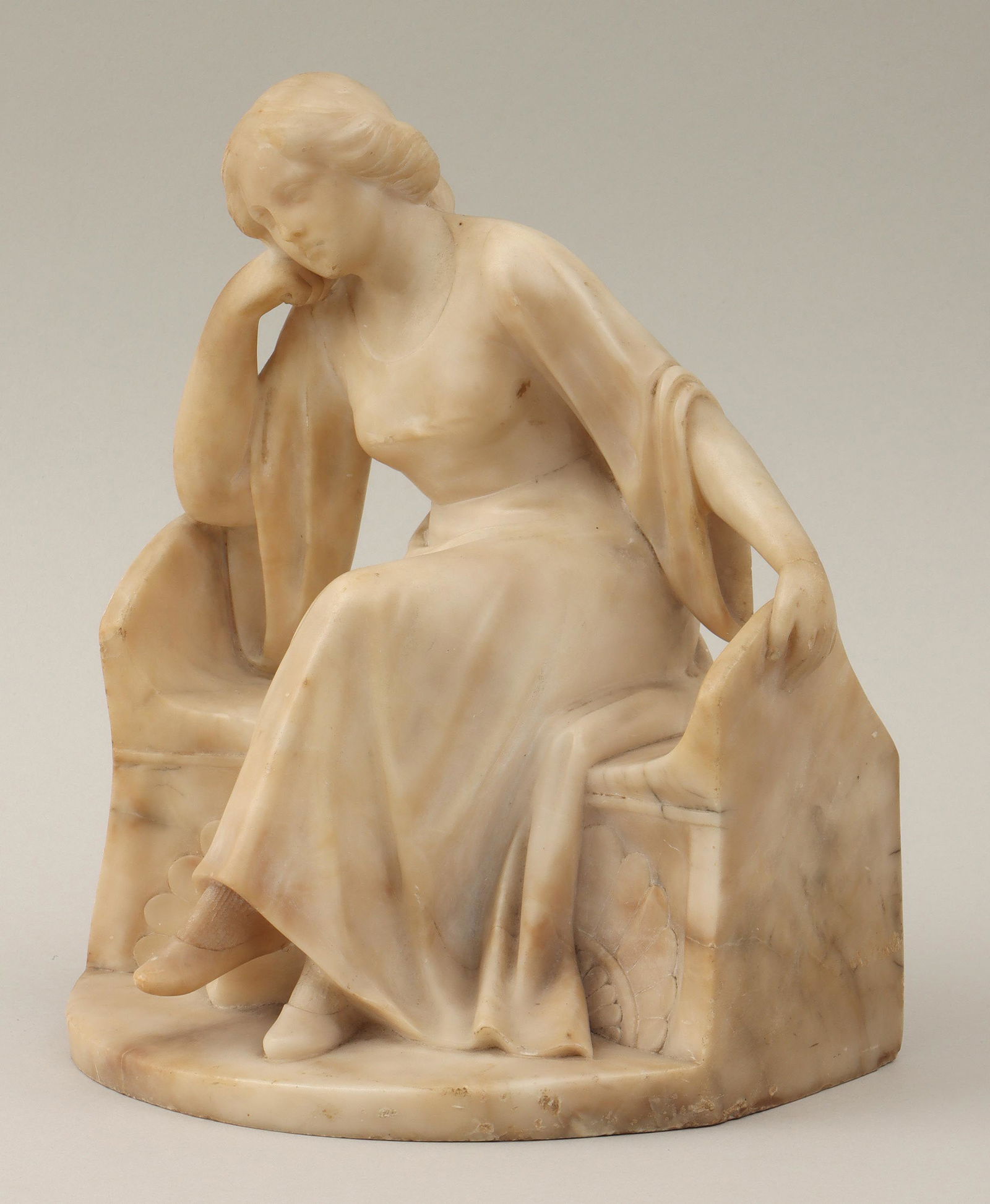 Italian School, carved alabaster: Italian School, carved alabaster sculpture of seated woman. Surface flakes and abrasions, some small chips, hairline at wrist. 10-1/4''h, 9''w, 6-3/4''d. IMPORTANT SHIPPING INFORMATION 1 - LIVE-SHIPPI