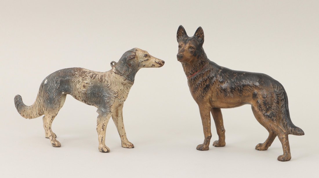 Cast iron dog doorstops: Group of (2) painted cast iron dog doorstops, to include: German shepherd; and greyhound. Paint loss. Larger (German shepherd) 9-1/4''h, 10-1/4''w, 4-1/2''d. IMPORTANT SHIPPING INFORMATION 1 - LIVE-SH