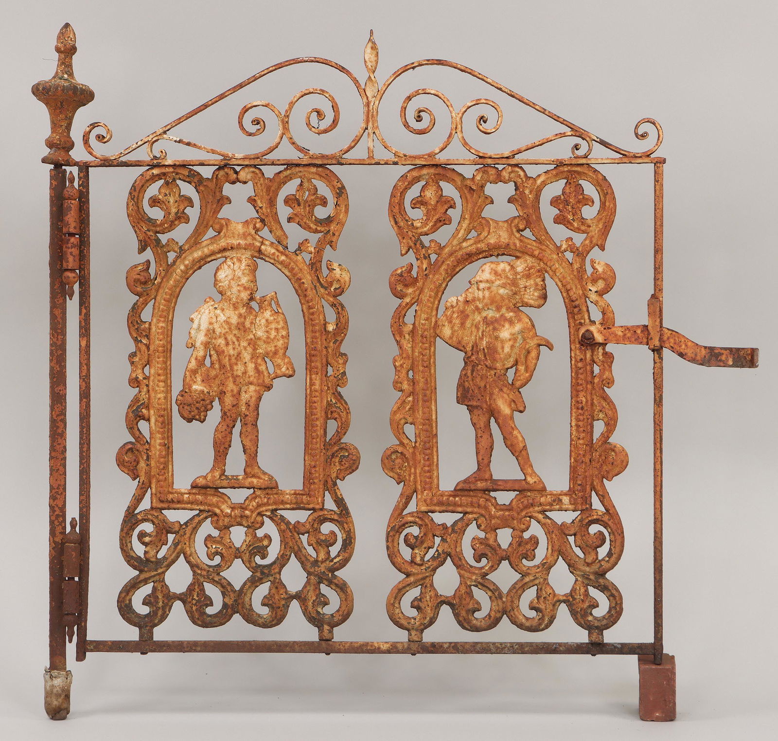Wrought iron gate: Wrought iron gate with two cast iron figural panels, one figure with wheat and sickle (personifying summer), the other with grapes and wine jug (personifying autumn), painted white. One panel with bre