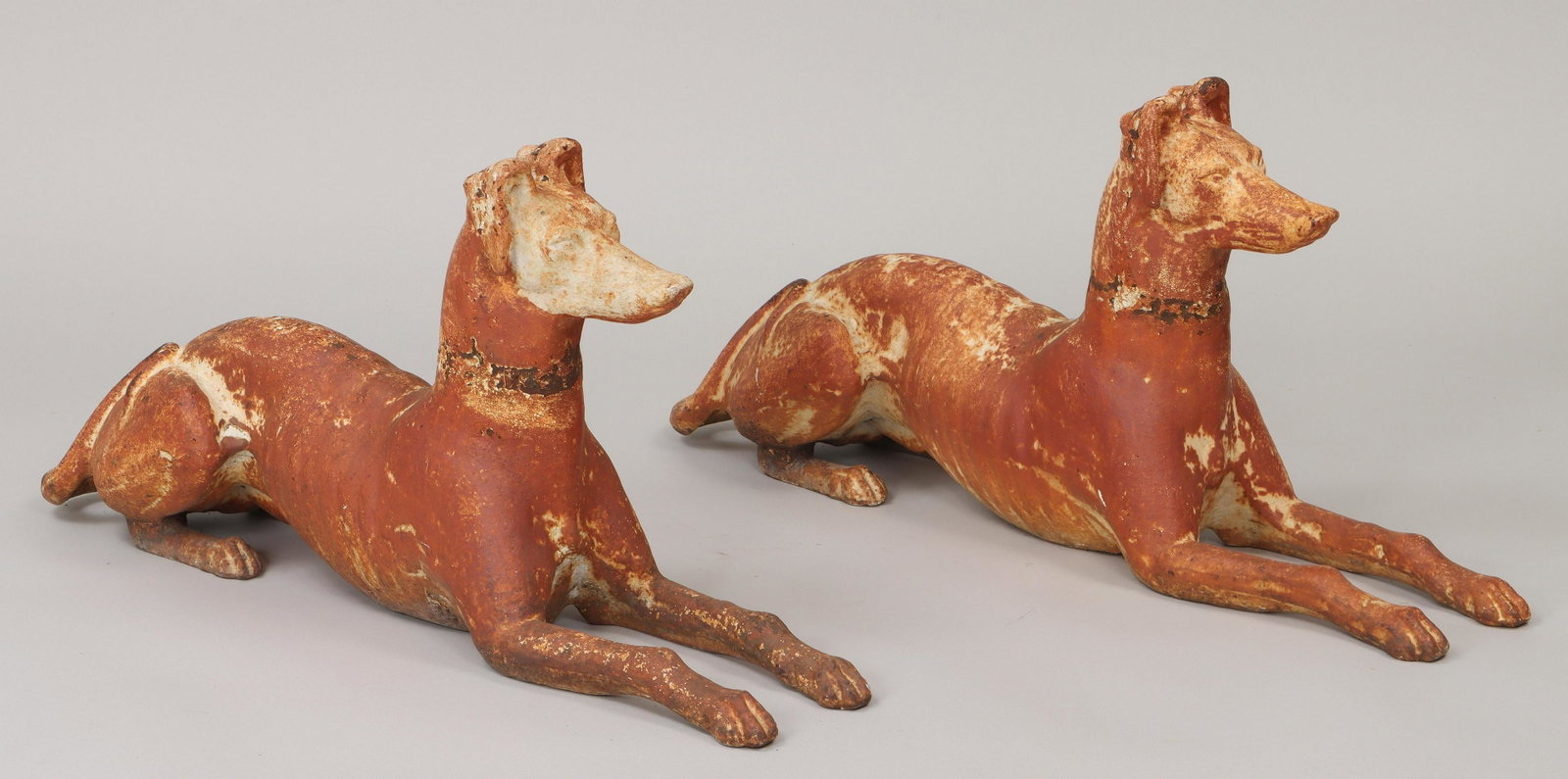 Pair of cast iron recumbent whippets: Pair of cast iron recumbent whippets. Paint loss, minor casting loss at bottom opening. 17-1/2''h, 38''l, 9''w. IMPORTANT SHIPPING INFORMATION 1 - LIVE-SHIPPING : The service is provided by Liveauctio