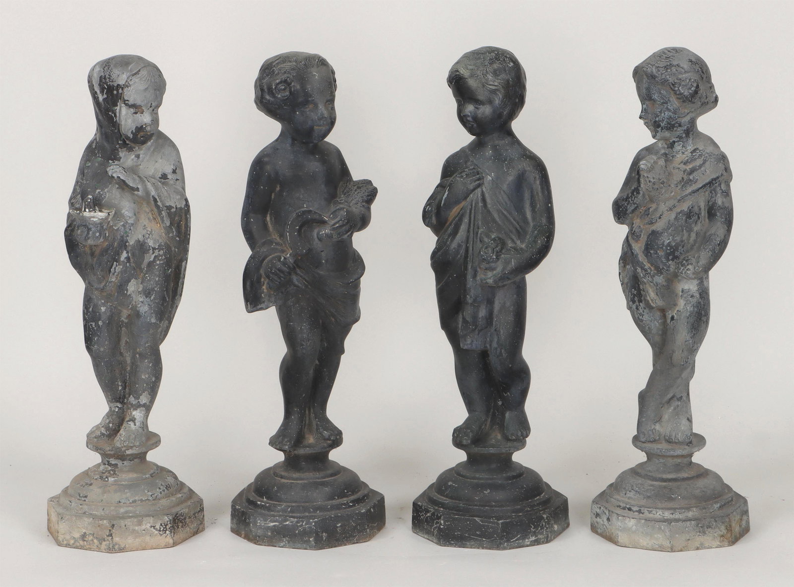 Set of (4) zinc putti garden statues: Set of (4) zinc putti garden statues representing the Four Seasons. Paint loss. Each 26''h. IMPORTANT SHIPPING INFORMATION 1 - LIVE-SHIPPING : The service is provided by Liveauctioneers. This option i
