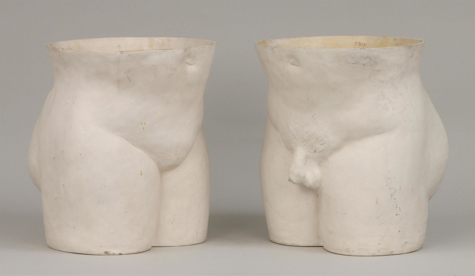 Male and female nude torso planters: Male and female nude torso planters, bisque porcelain. A few chips to rim and base of each, stains, accretions and minor abrasions. Larger (male) 13''h, 11-1/2''w, 11-3/4''d. IMPORTANT SHIPPING INFORM