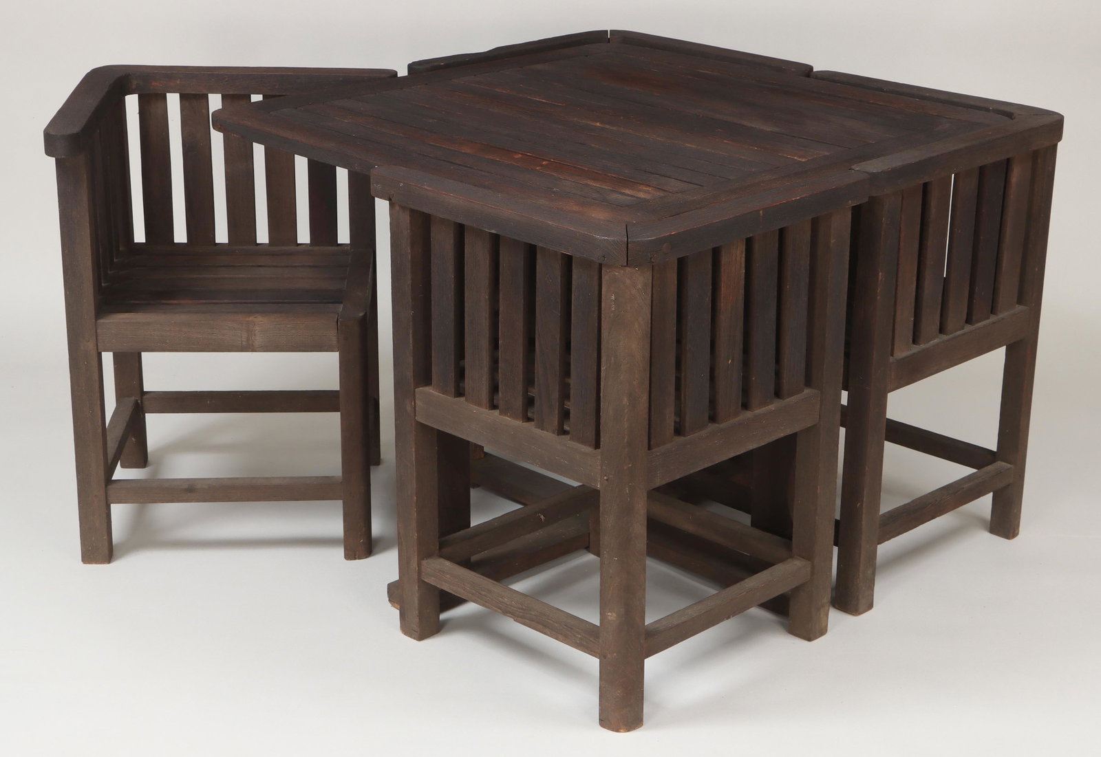 Five-piece teak relic wood garden set: Five-piece teak relic wood garden set, made from the deck of the HMS Ajax, to include: table; and (4) arm chairs. Marked ''Battleship Teakwood'', London. Joints loose. Table 28''h, 36''sq. Catalog not