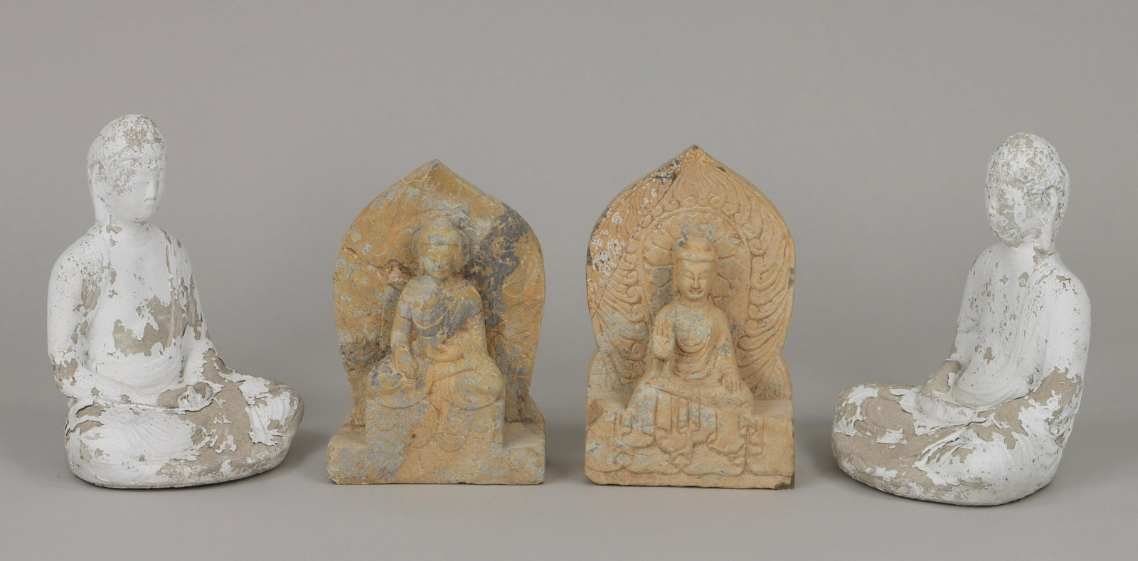 Group of (4) Buddha garden statues: Group of (4) Buddha garden statues, to include: set of (2) cast cement Buddha figures, painted white; and set of (2) cast stone Buddha figures, painted tan, (filled and repaired cracks). Paint loss an