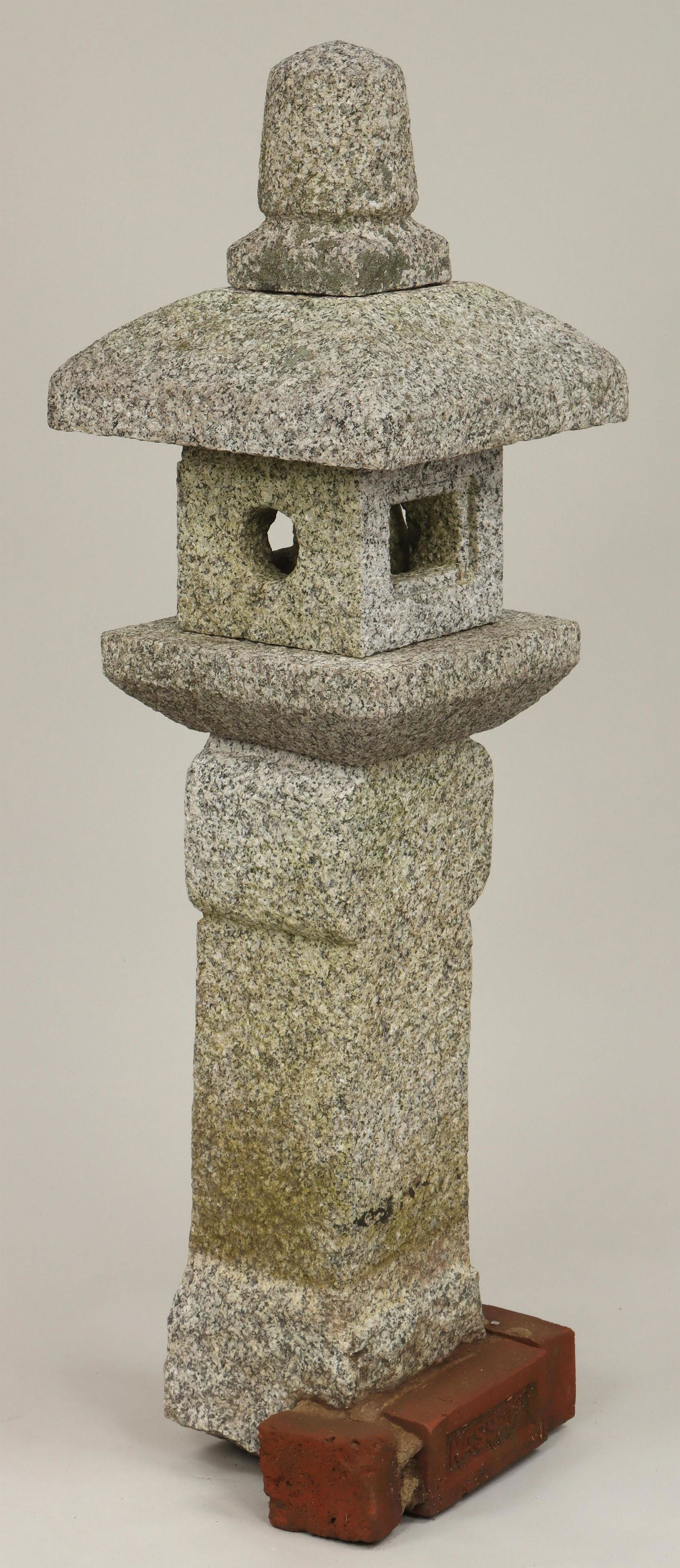 Carved granite pagoda, in five parts: Carved granite pagoda, in five parts. Brick remnants to base from previous setting. 52-1/2''h, 14-3/4''sq. IMPORTANT SHIPPING INFORMATION 1 - LIVE-SHIPPING : The service is provided by Liveauctioneers
