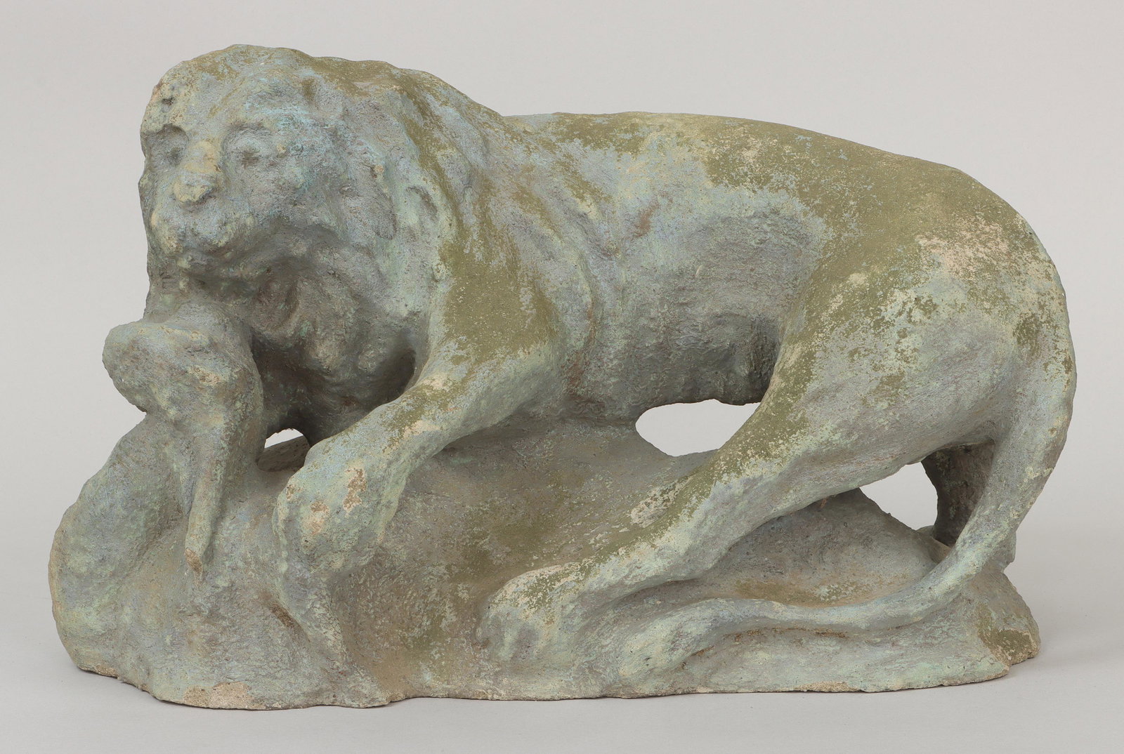 THEOPHILUS ANTHONY BROUWER, JR.: THEOPHILUS ANTHONY BROUWER, JR. (American, Long Island, 1864-1932), male lion, green-painted cast stone, signed ''Brouwer''. Weathered, chips to base and loss to one back foot. 10-1/2''h, 17-1/2''w, 9