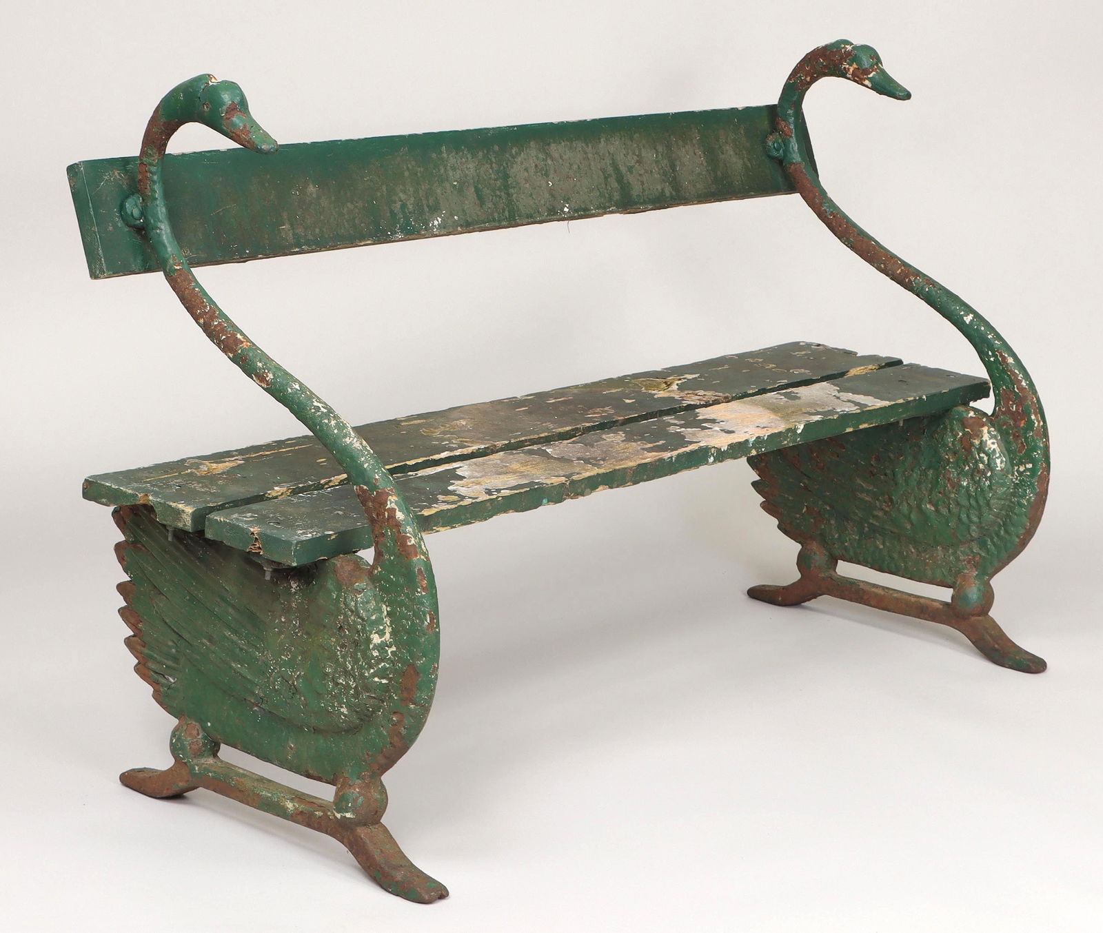 Cast iron swan garden bench: Cast iron swan garden bench with wood slat seat and back, 19th/20th century. Minor loss to front of one foot, wood slats weathered and with losses. 35-1/4''h, 59-3/4''w, 22''d. IMPORTANT SHIPPING INFO