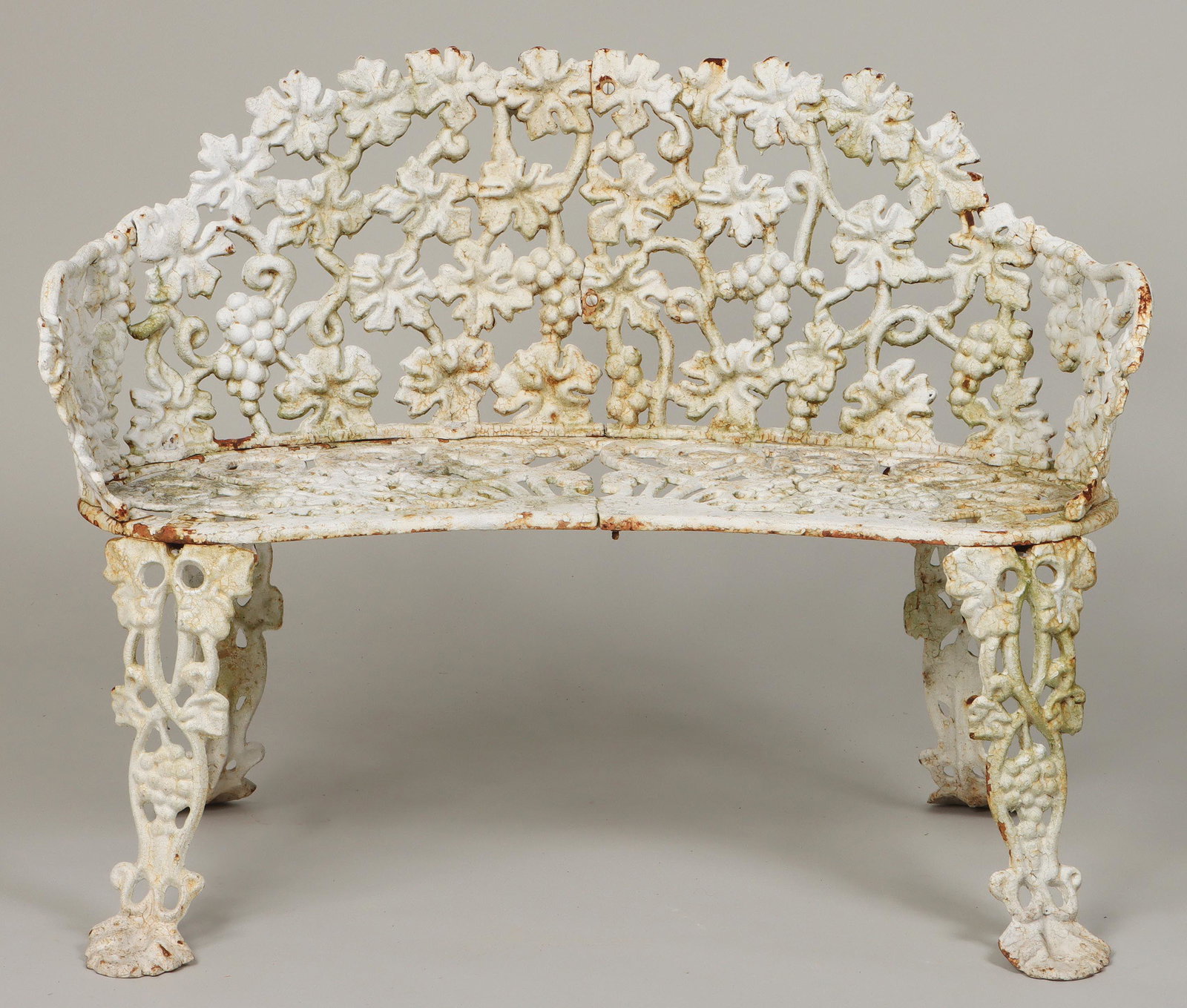 Cast iron garden bench: Cast iron garden bench in grapevine pattern, painted white. Two hairlines. 29''h, 35-1/2''w, 21''d. IMPORTANT SHIPPING INFORMATION 1 - LIVE-SHIPPING : The service is provided by Liveauctioneers. This 