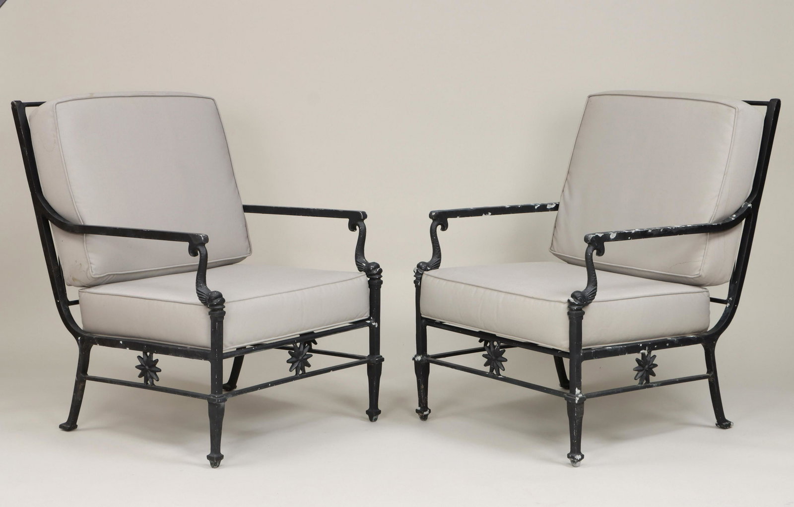 Pair of Florentine cast aluminum lounge chairs: Pair of Florentine cast aluminum lounge chairs with dolphin-form arms and gray cushions. Paint loss, some stains to cushions. 35-1/4''h, 25-1/4''w, 31-1/4''d. IMPORTANT SHIPPING INFORMATION 1 - LIVE-S