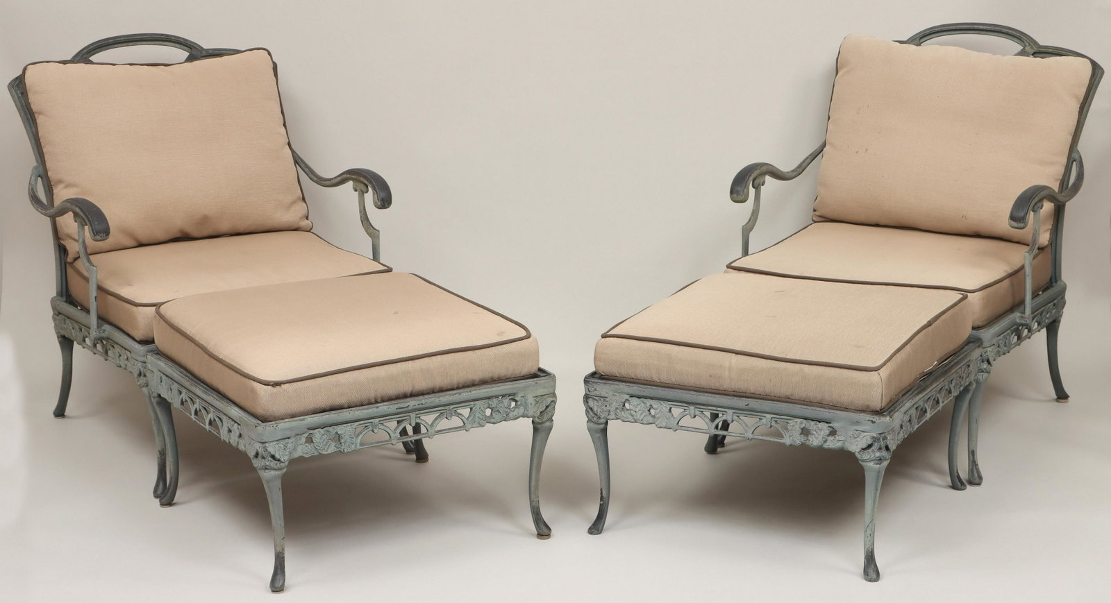 Pair of cast aluminum lounge armchairs: Pair of cast aluminum lounge armchairs with ottomans, in brushed green finish, with cushions. Stains to cushions. Armchair 33-3/4''h, 26-1/2''w, 32''d. IMPORTANT SHIPPING INFORMATION 1 - LIVE-SHIPPING