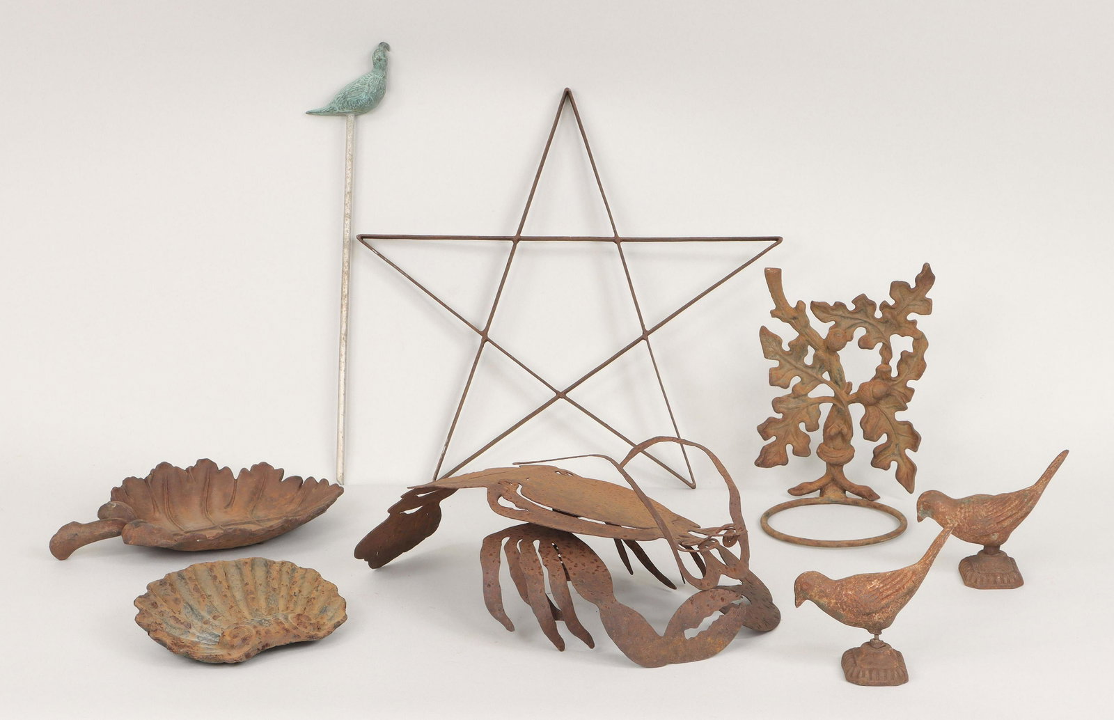 Group of (8) metal garden decorations: Group of (8) metal garden decorations, to include: (3) birds, comprised of two cast iron, and one verdigris bronze bird on aluminum stake; pierced steel lobster; wrought iron star; cast iron scallop s