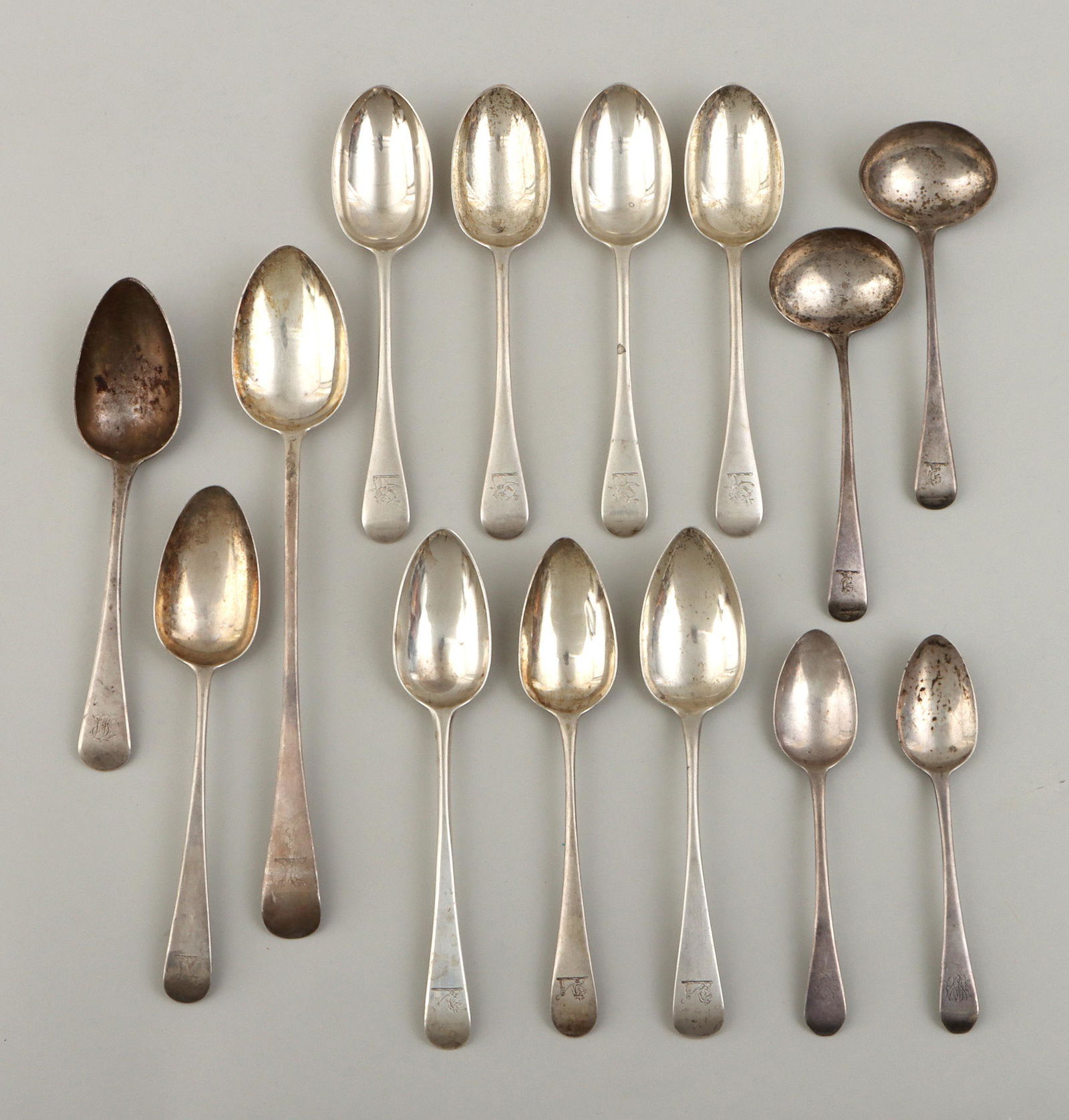 Georgian and Victorian sterling spoons: Group of (14) Georgian and Victorian sterling silver spoons, London, with engraved animals on handles, to include: Victorian serving spoon, George William Adams, 1877, with bird heads; pair of George