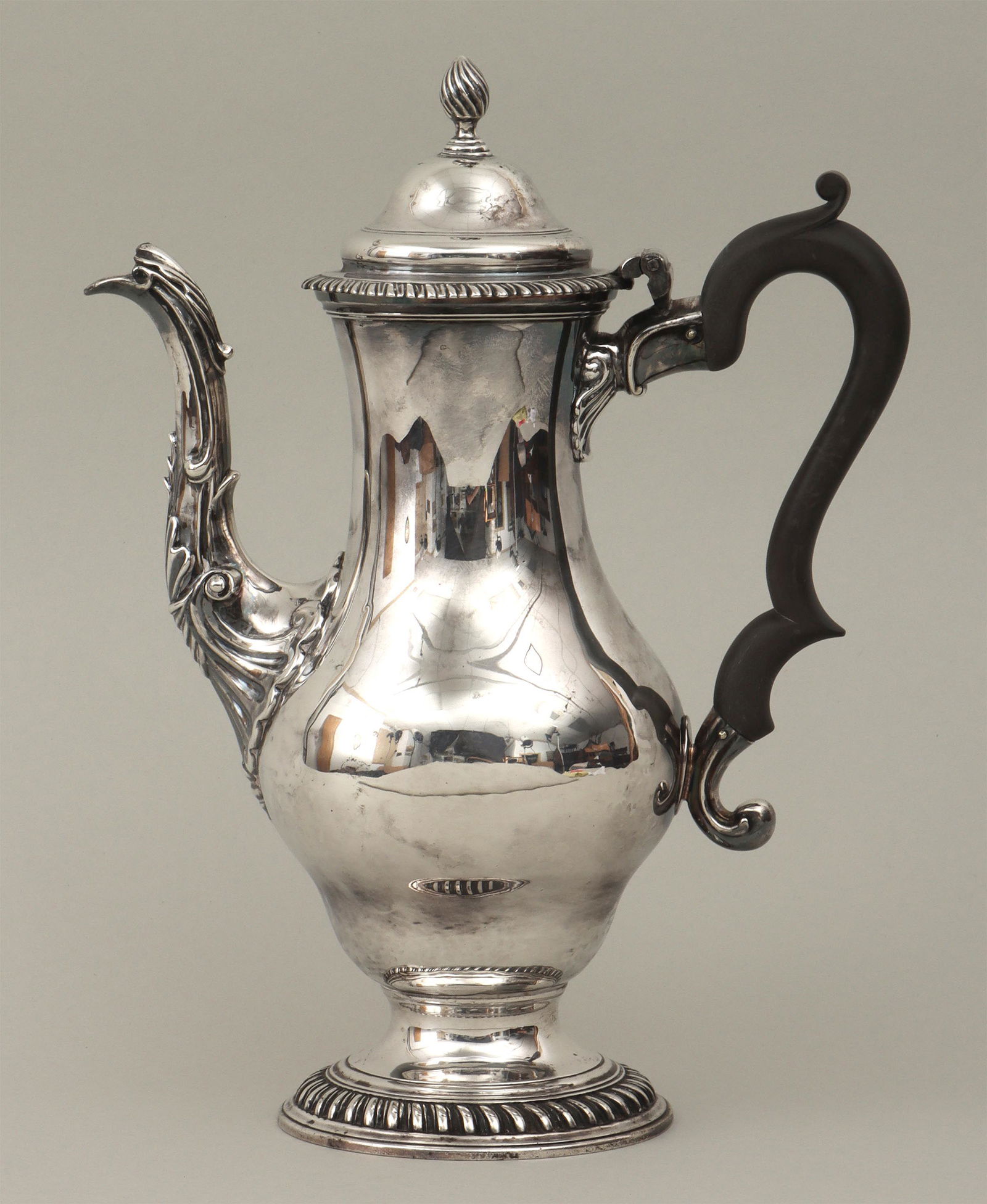 George III sterling silver coffeepot: George III sterling silver coffeepot, Daniel Smith & Robert Sharp, London, 1767, having hinged, domed lid with flame finial, wood scroll handle, spout with leaves and shells, and gadrooned borders, ha