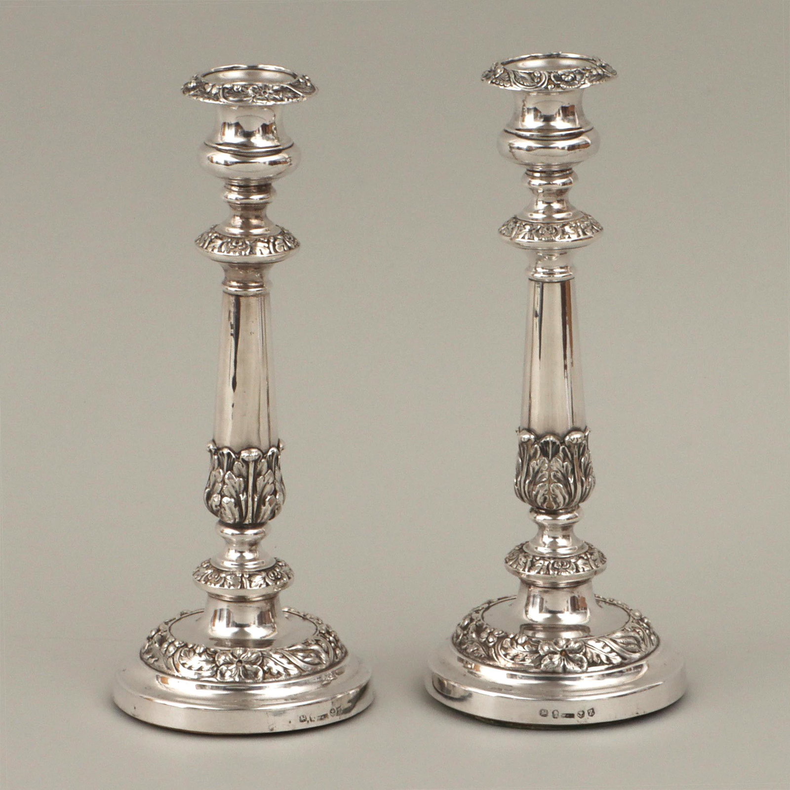 Pair of George III sterling candlesticks: Pair of George III weighted sterling silver candlesticks, Birmingham, 1797, with scrolled floral and foliate design in relief, hallmarked on side with ''W & R'' maker's mark in a rectangular cartouche