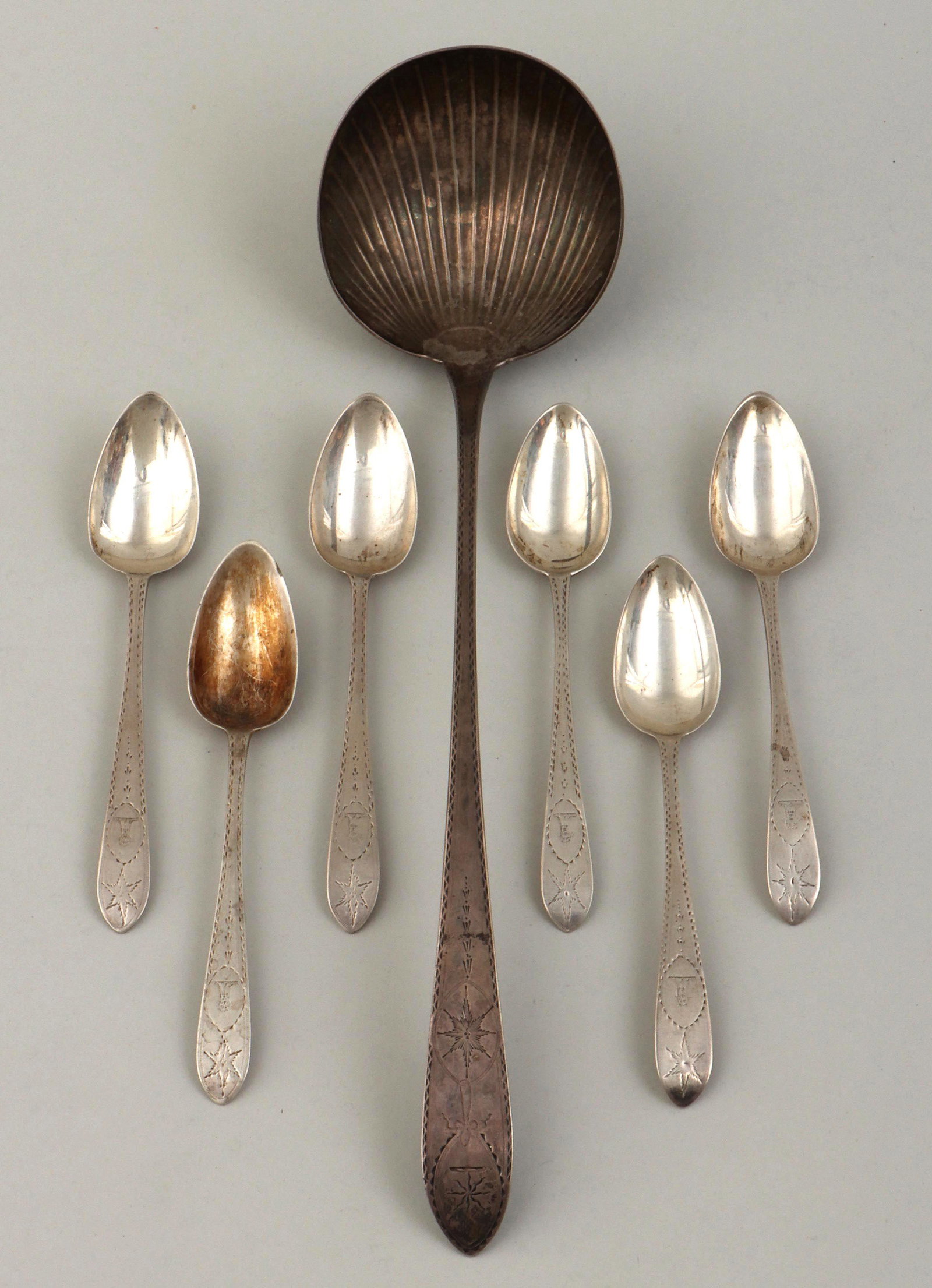 Irish Georgian sterling silver spoons: Group of (7) Irish Georgian sterling silver spoons, Dublin, having bright-cut patterns with starbursts, to include: large Irish George I ladle, John Shields, 1723, with ribbed bowl; and assembled set 